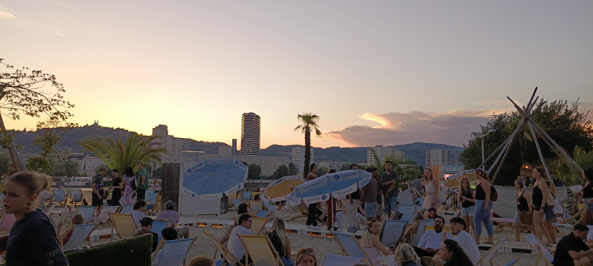 Linz riverbank fills up for a golden-hour summer evening