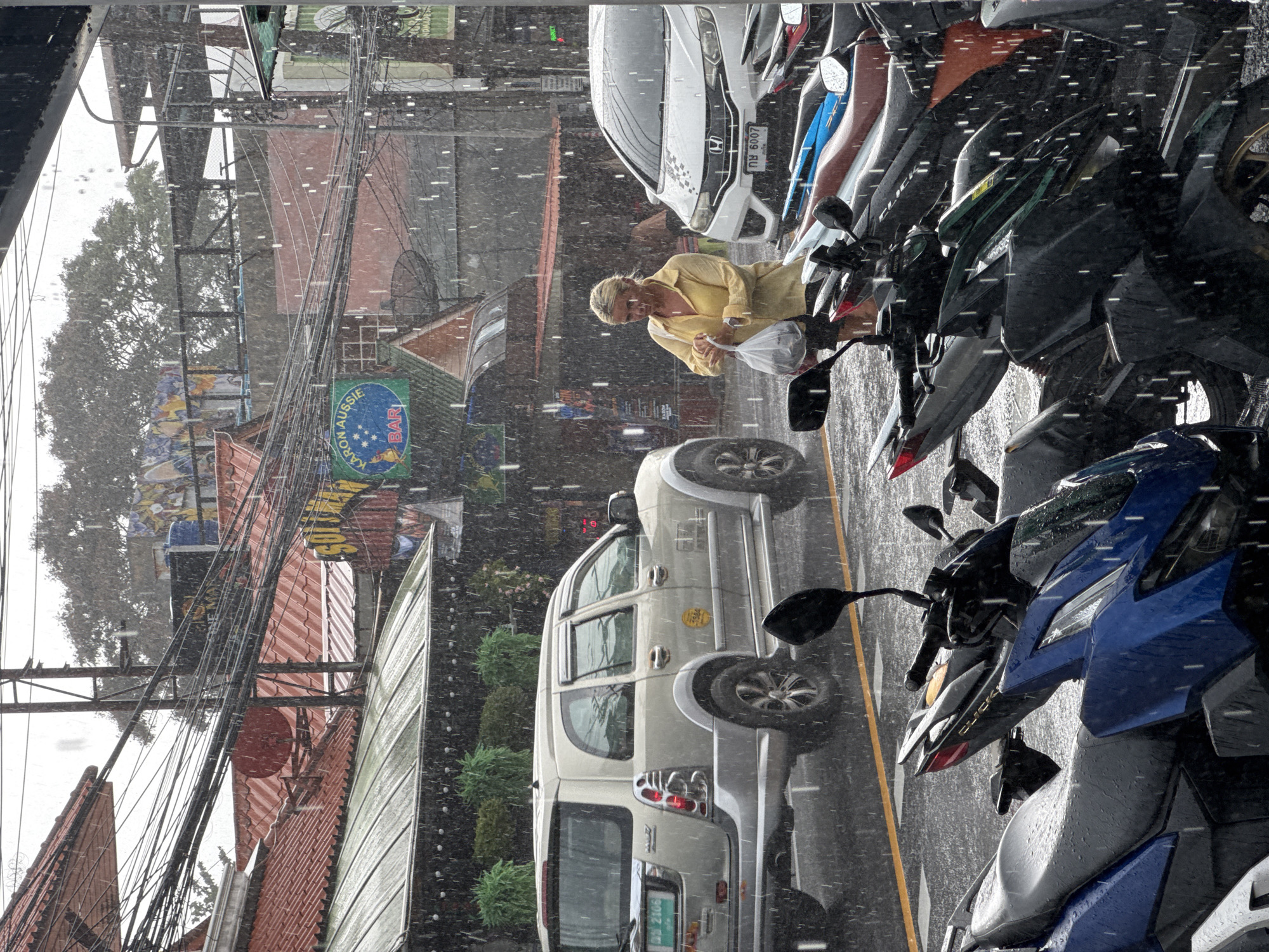 Karon street life during a morning rain shower, Phuket