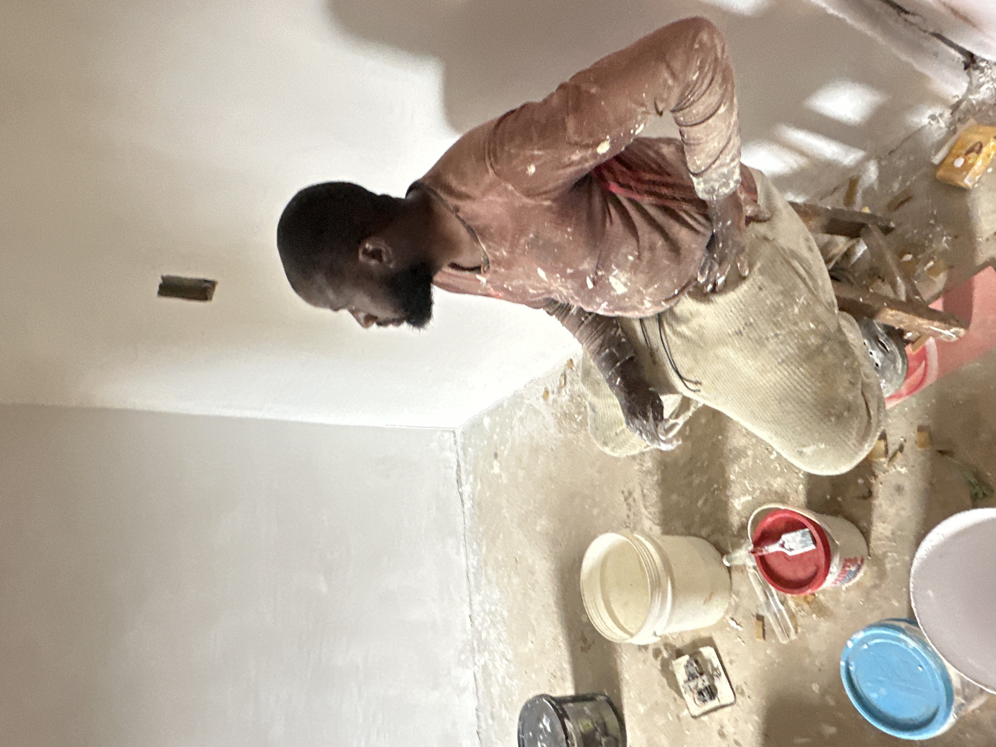 Construction worker renovates interior room in Bukuru, Nigeria