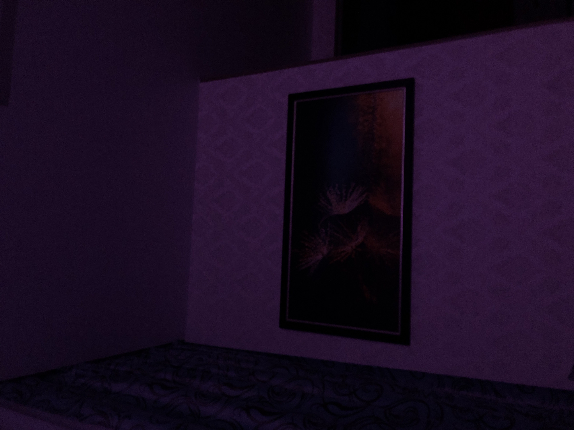 Witness captures dimly lit interior with screens, staircase