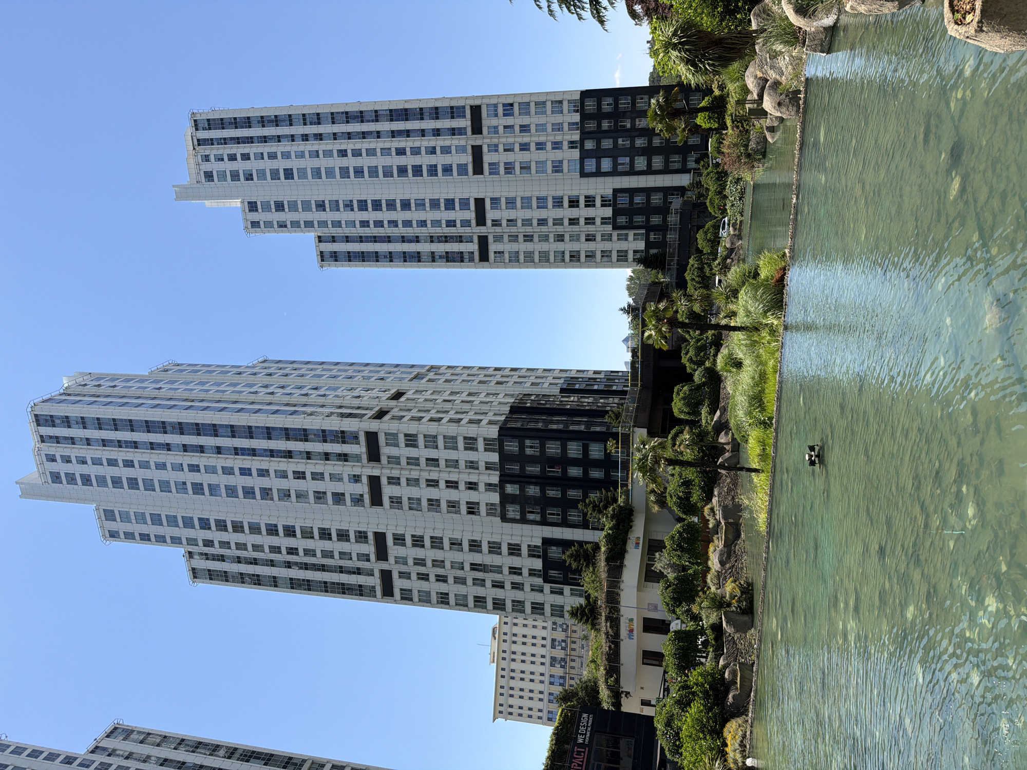 Modern Sarıyer streetside: buildings, water feature, parked minivan