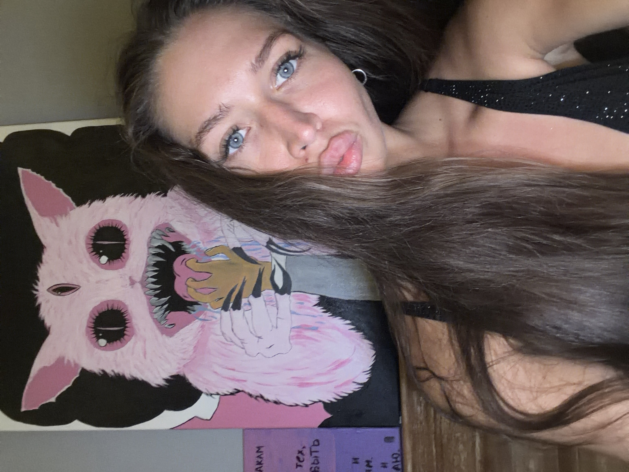 Woman poses with cartoon monster artwork in Canggu