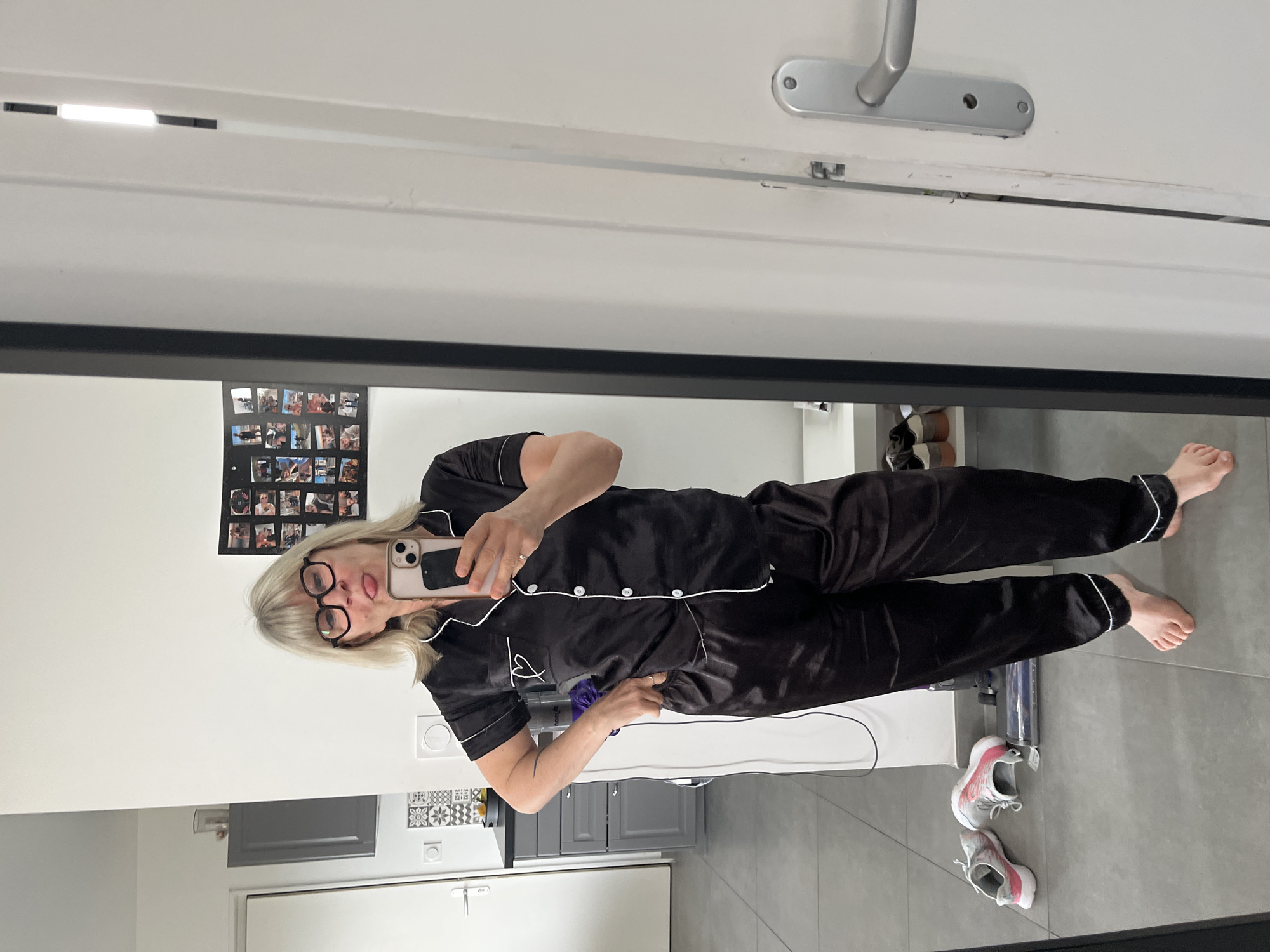 Woman takes playful mirror selfie in pajamas