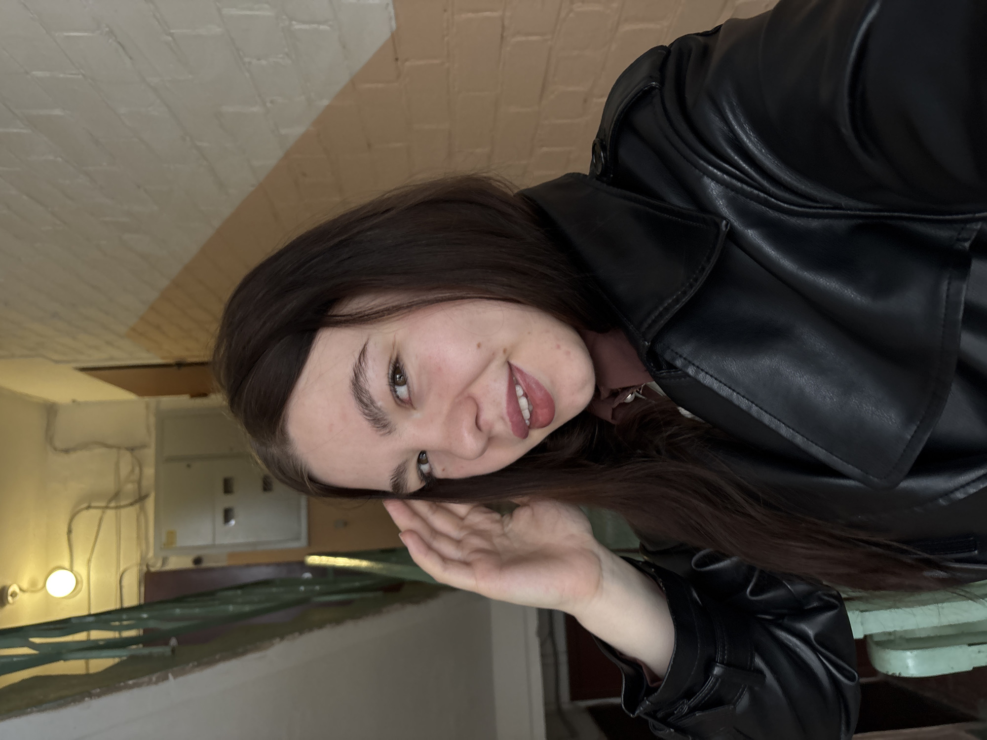 Woman in leather jacket photographed inside building in Perm
