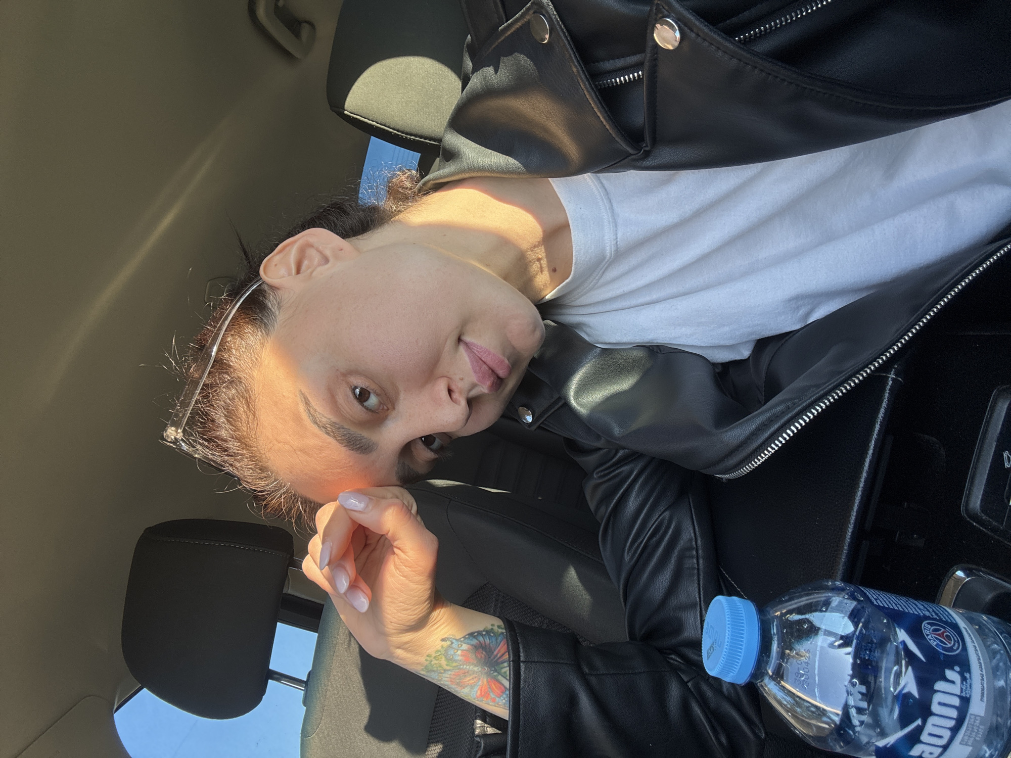 Woman in leather jacket photographed in car, Tbilisi landscapes