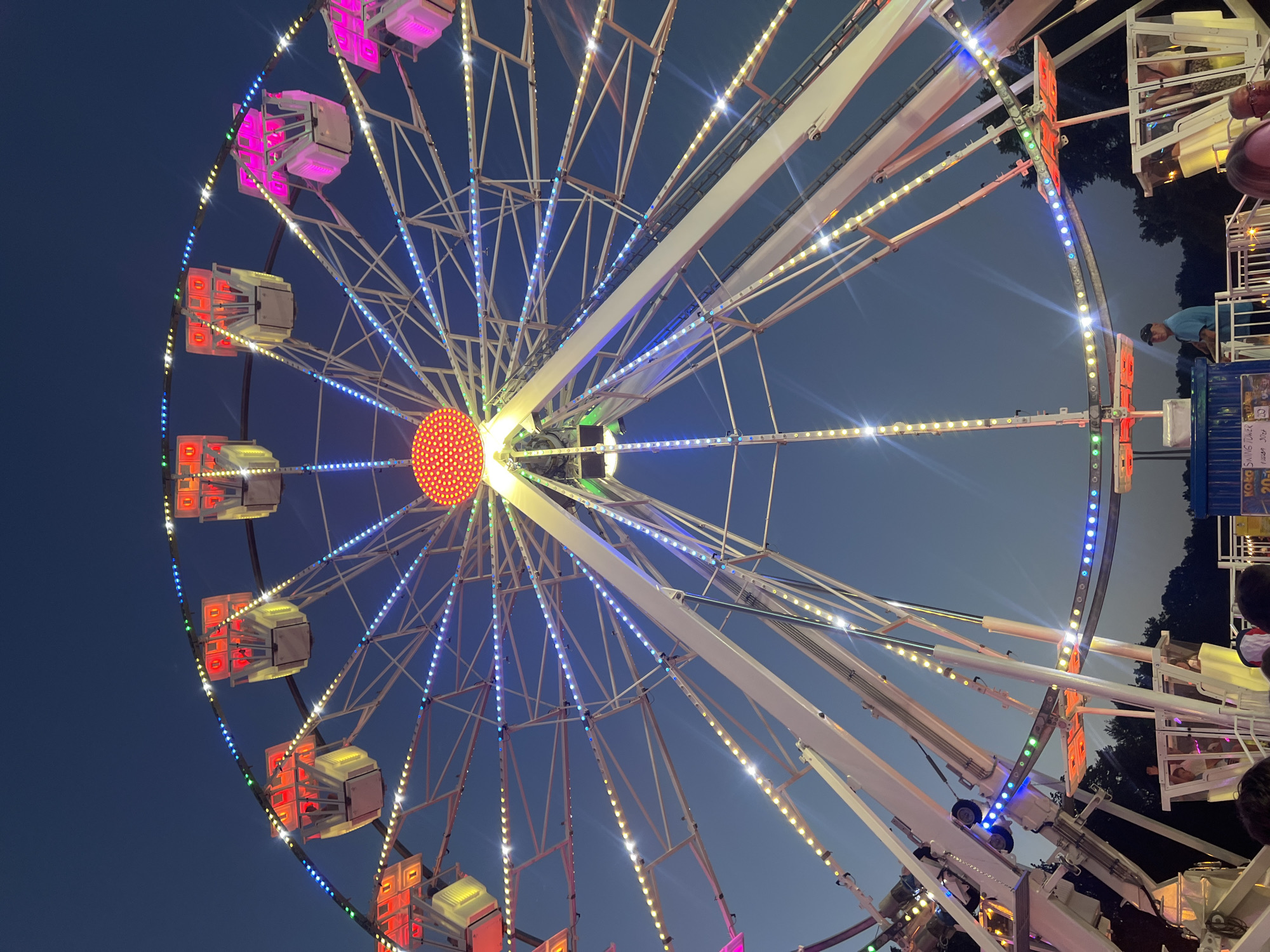 Fairground rides light up Tychy at dusk