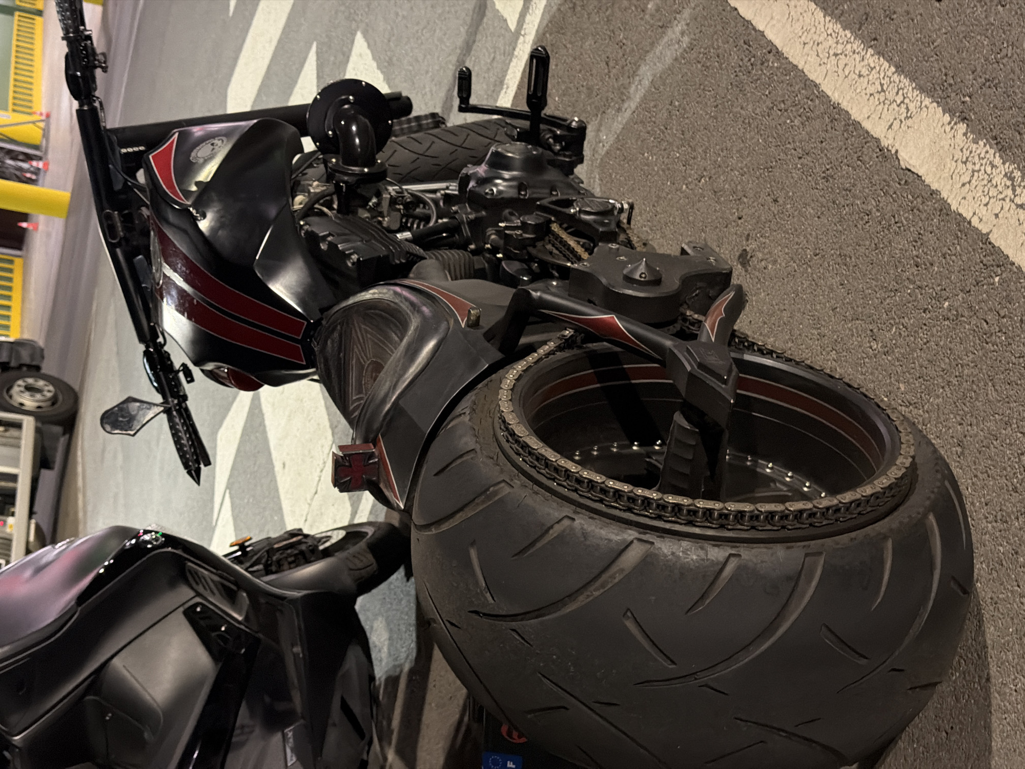Custom black and red motorcycle parked in Leudelange, Luxembourg