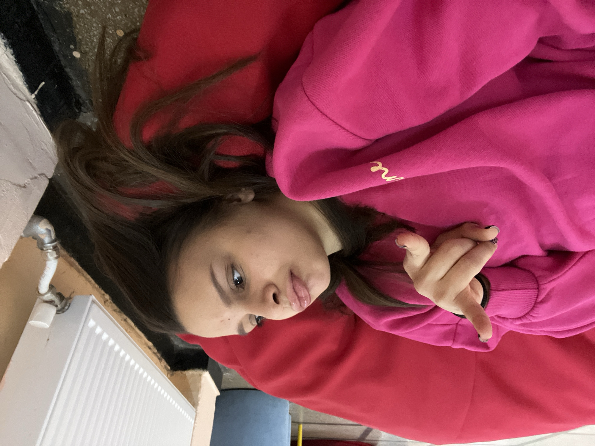 Woman poses on red cushion in STEM facility
