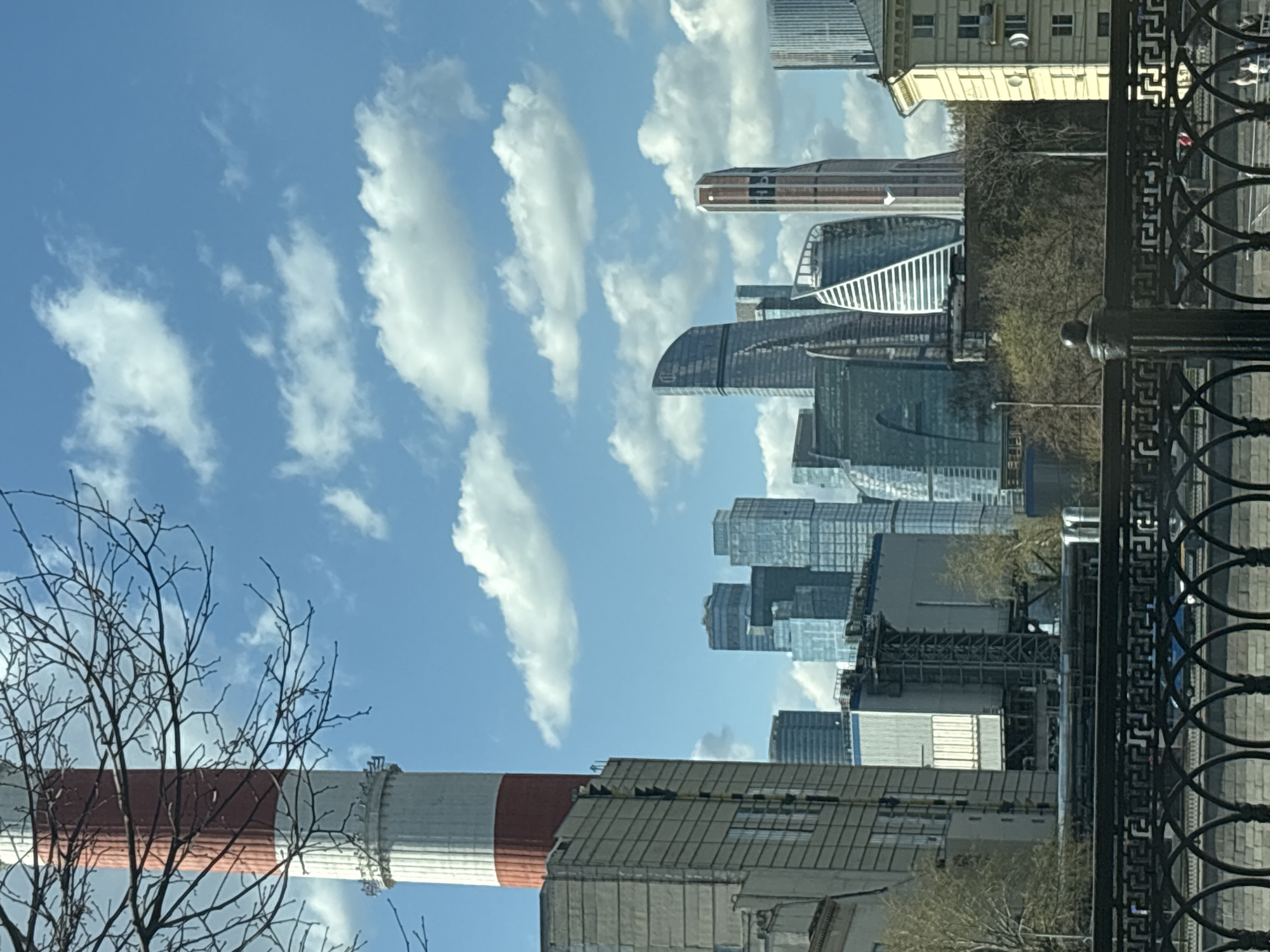 Moscow City skyline captured under partly cloudy April afternoon