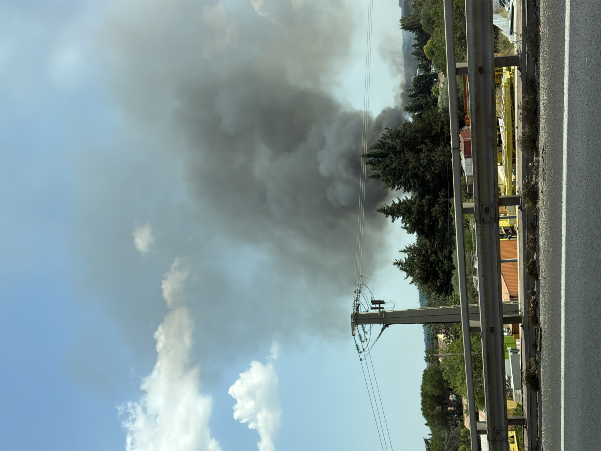 Dark smoke plume rises over Milhaud in midday fire