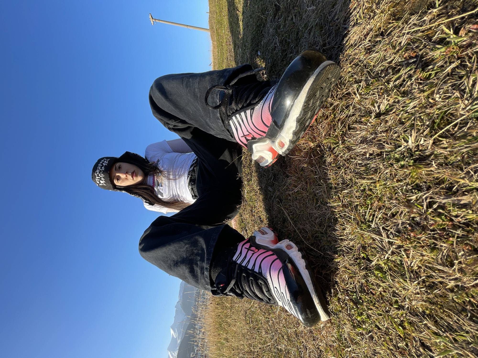 Woman rests on grass in Ushuaia, Argentina