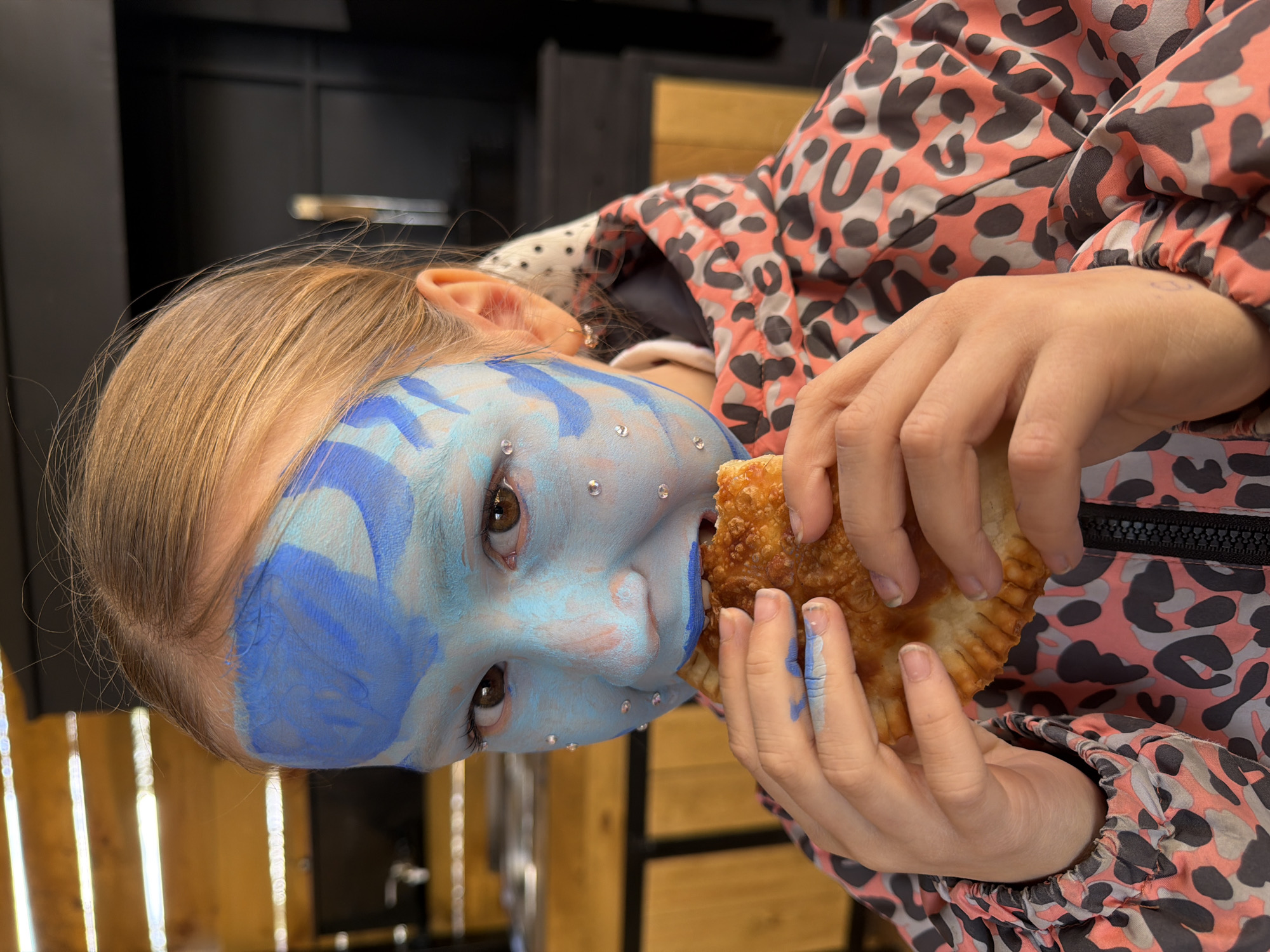 Young person spotted with ornate blue face paint in Dubovaya