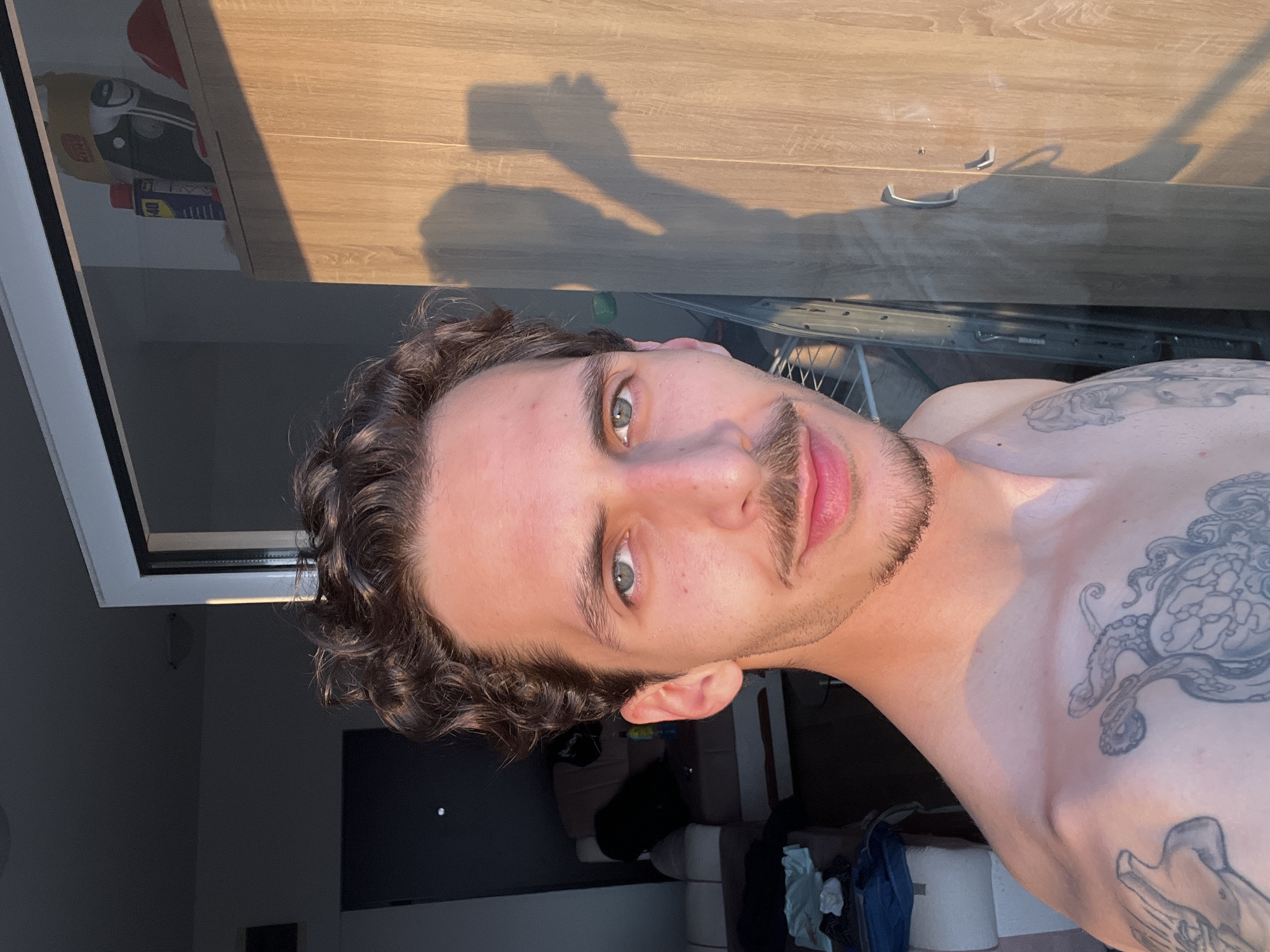 Tattooed man takes selfies in Montenegro coastal resort area