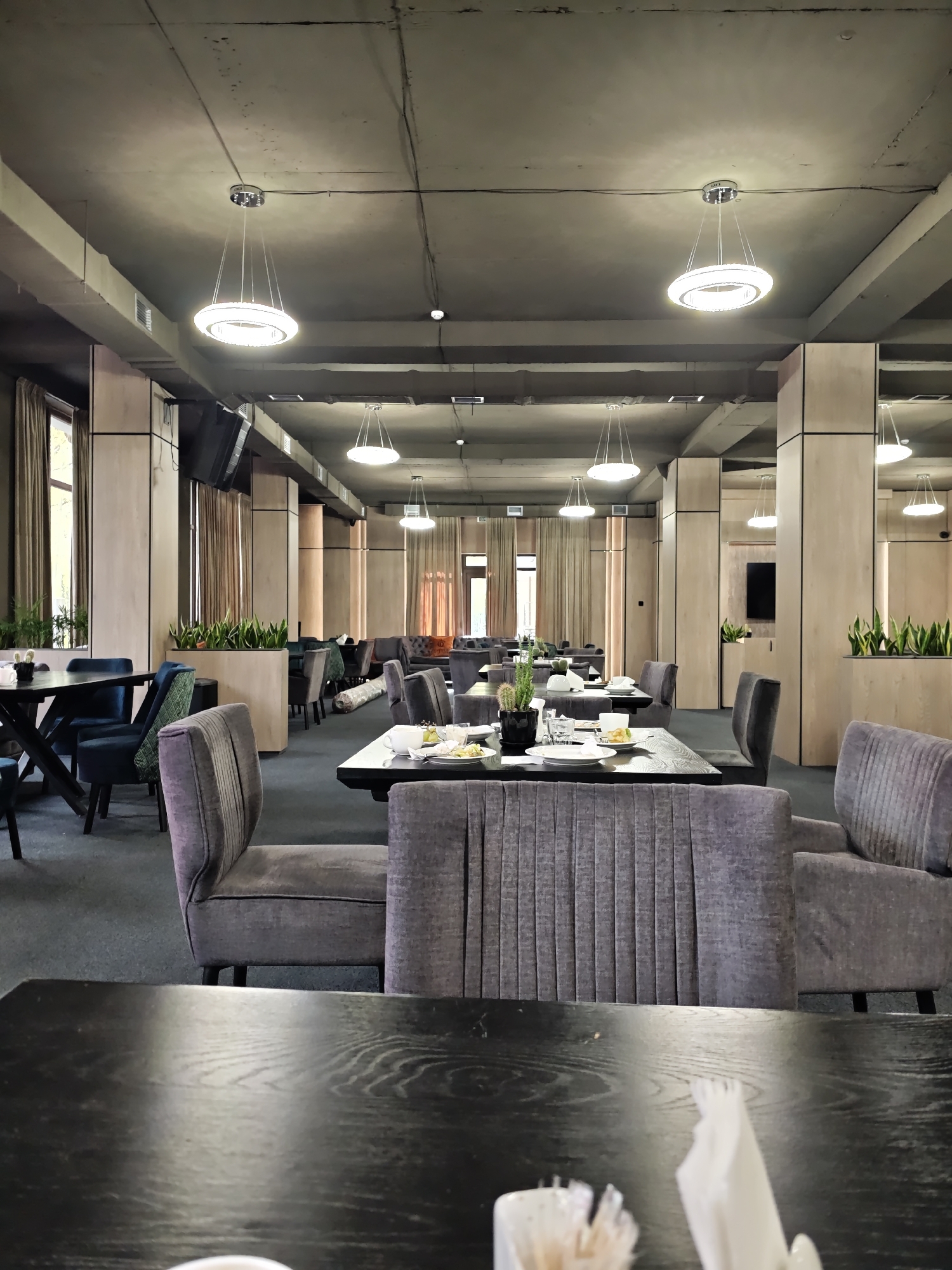 Empty restaurant with set tables captured by witness
