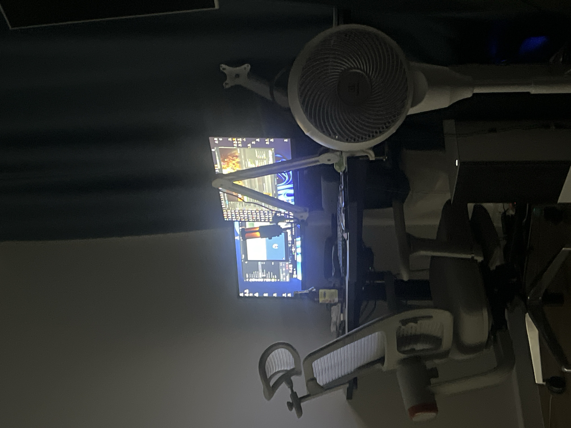 Home gaming setup with dual monitors and PlayStation controller