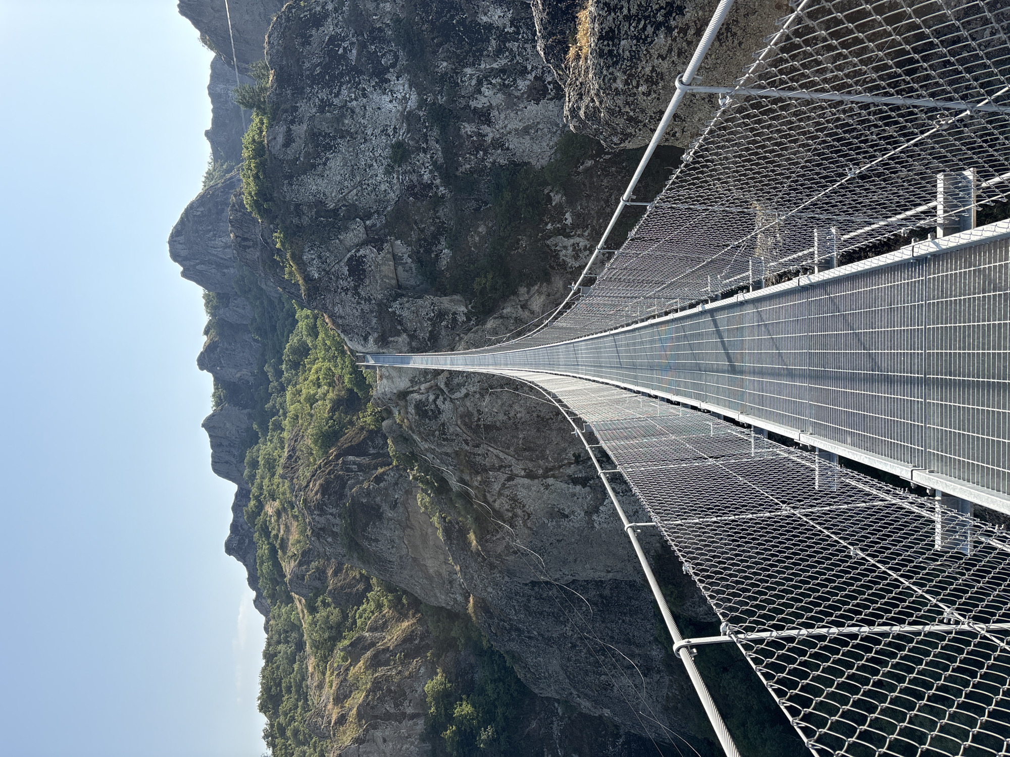 Suspension bridge over a deep canyon in Orbeti, Georgia