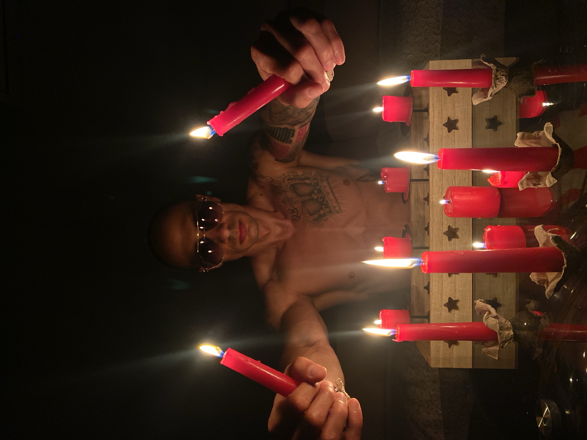 Candlelit gathering with tattoos and sunglasses in Pleven