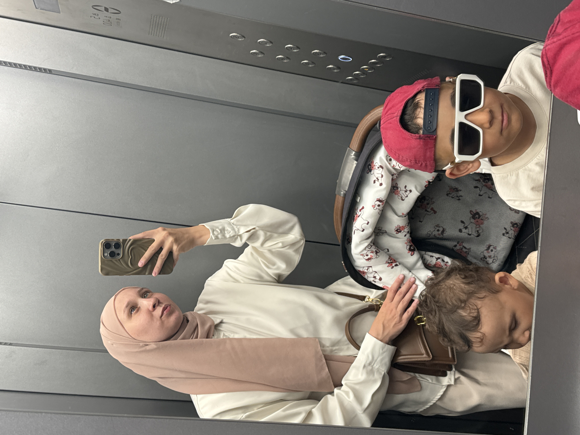 Woman and children photographed in elevator in Chaikovsky, Russia