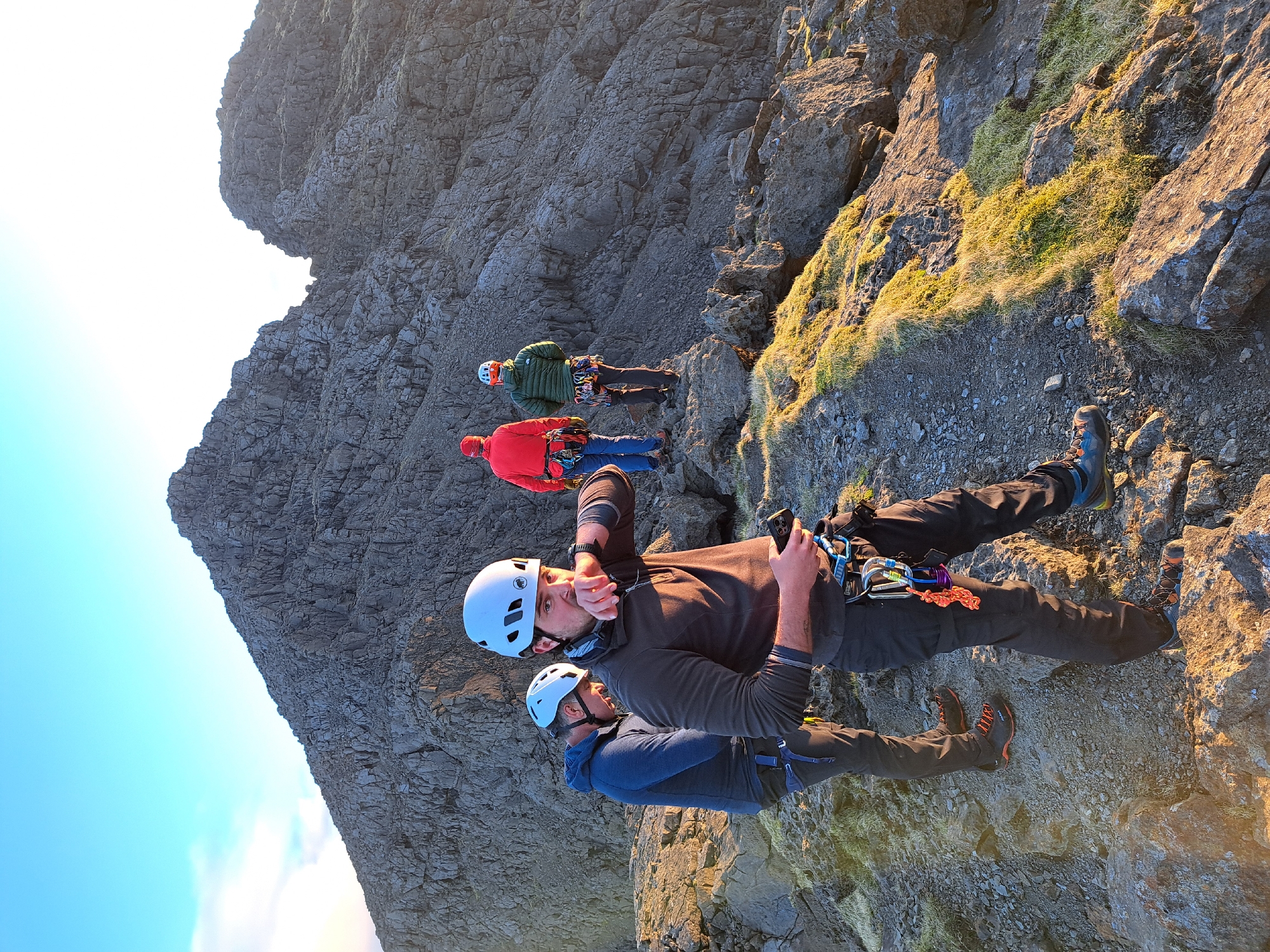 Climbers scale rocky mountainside in Carbost, UK