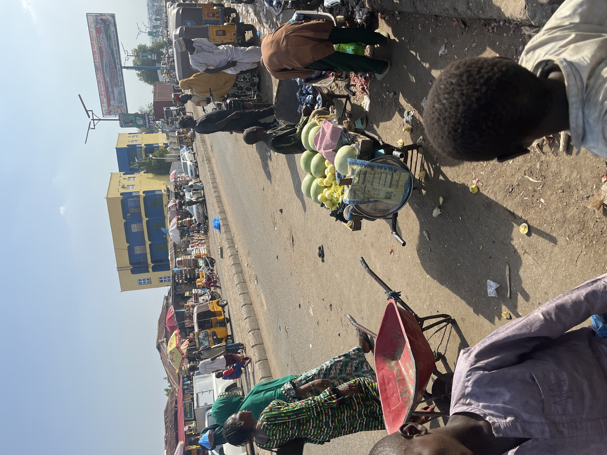 Busy market day captured across multiple vendor stalls in Minna