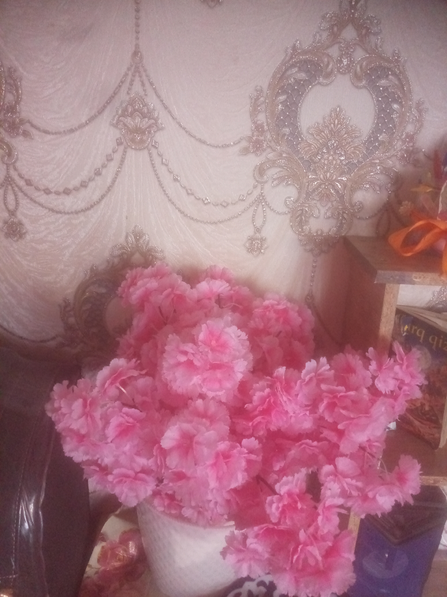 Inside a decorated Namangan room with flowers and books
