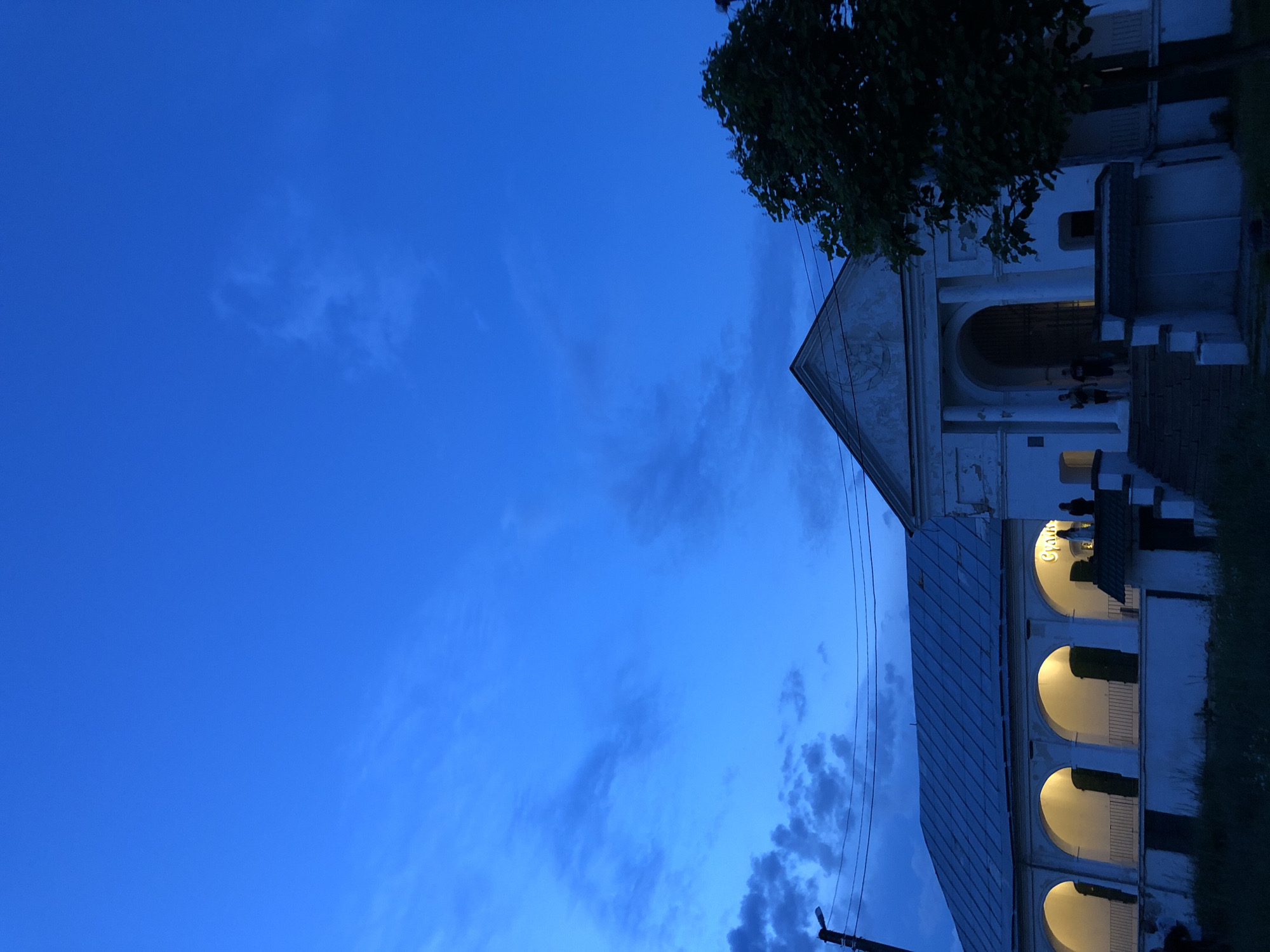 Twilight scenes around a lit colonial building and nearby streets