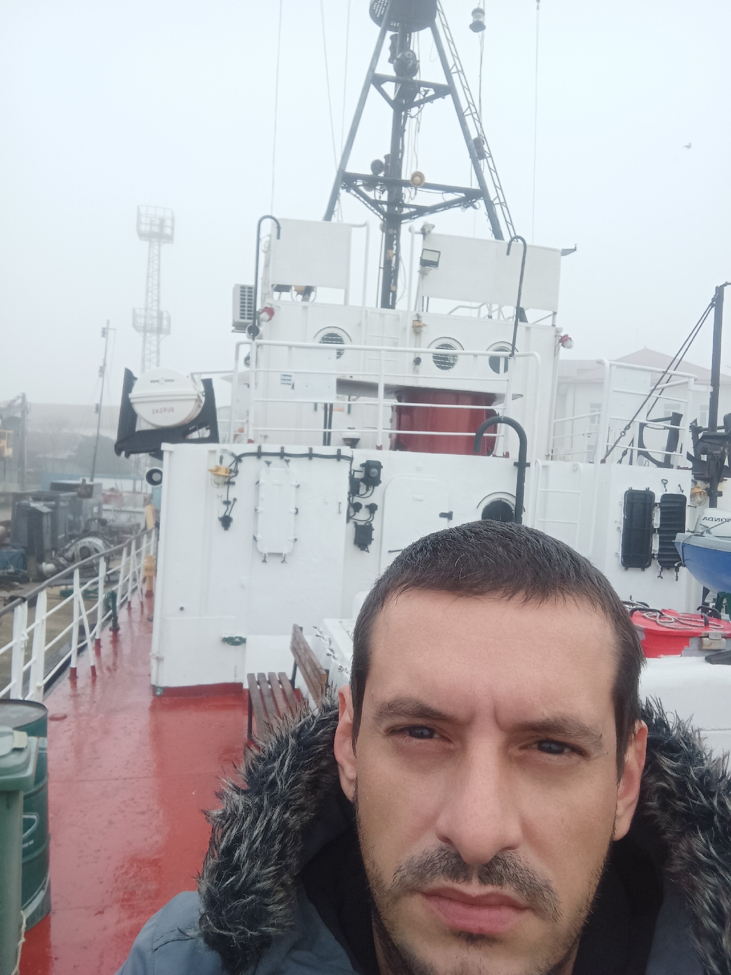 Man takes selfie on ship in foggy Burgas harbor
