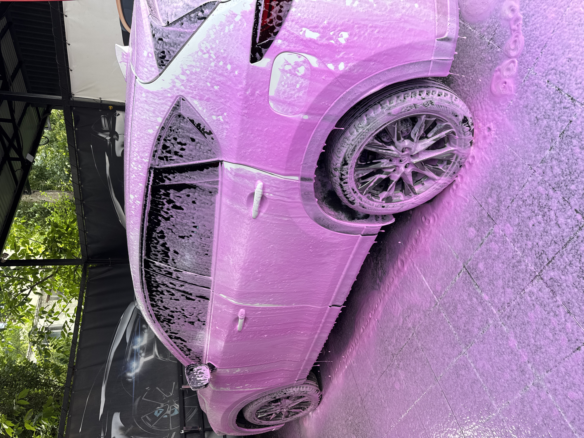 SUV covered in pink foam at a Rozdilna car wash