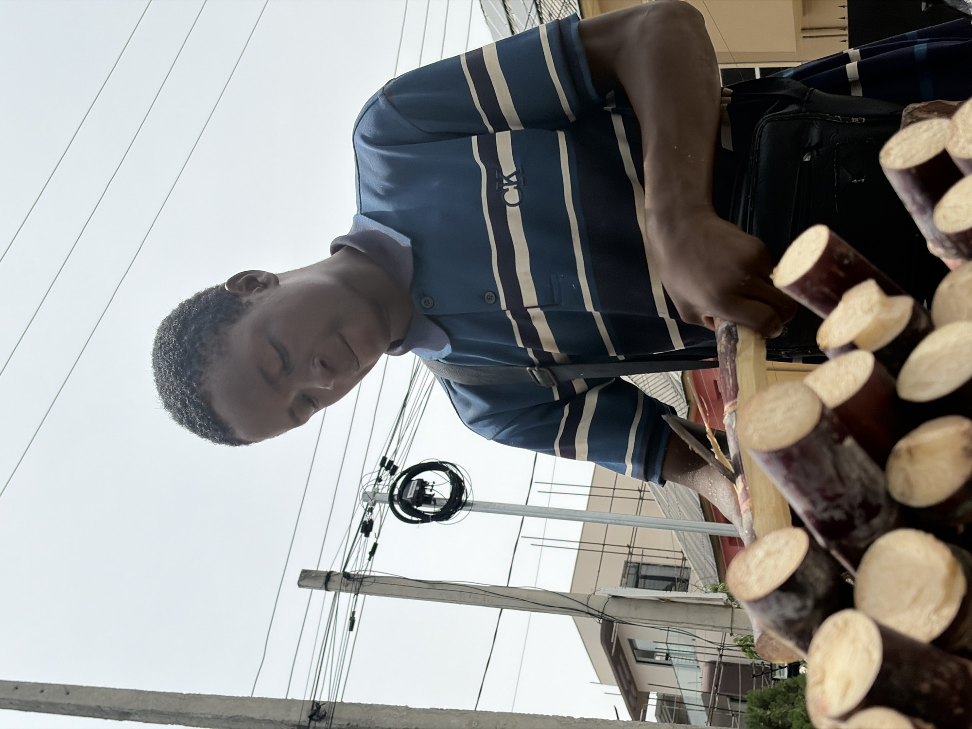 Sugarcane vendor prepares fresh stalks in Igboefon, Nigeria