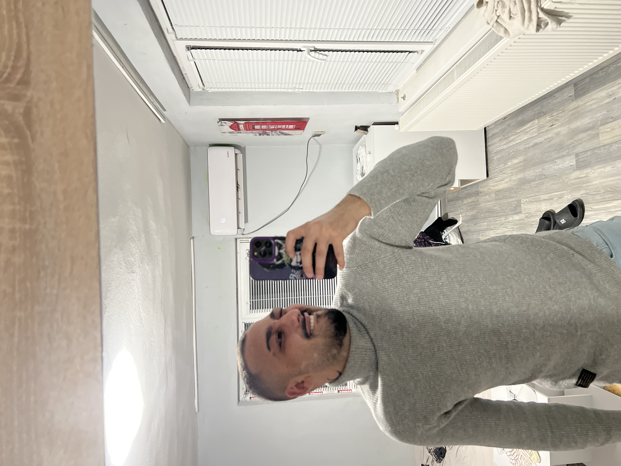 Man takes mirror selfie with purple phone in Shumata