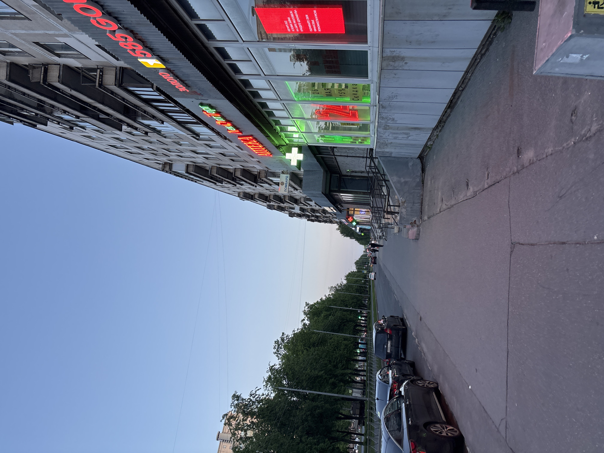Urban street scene with multi-story building documented in Russia
