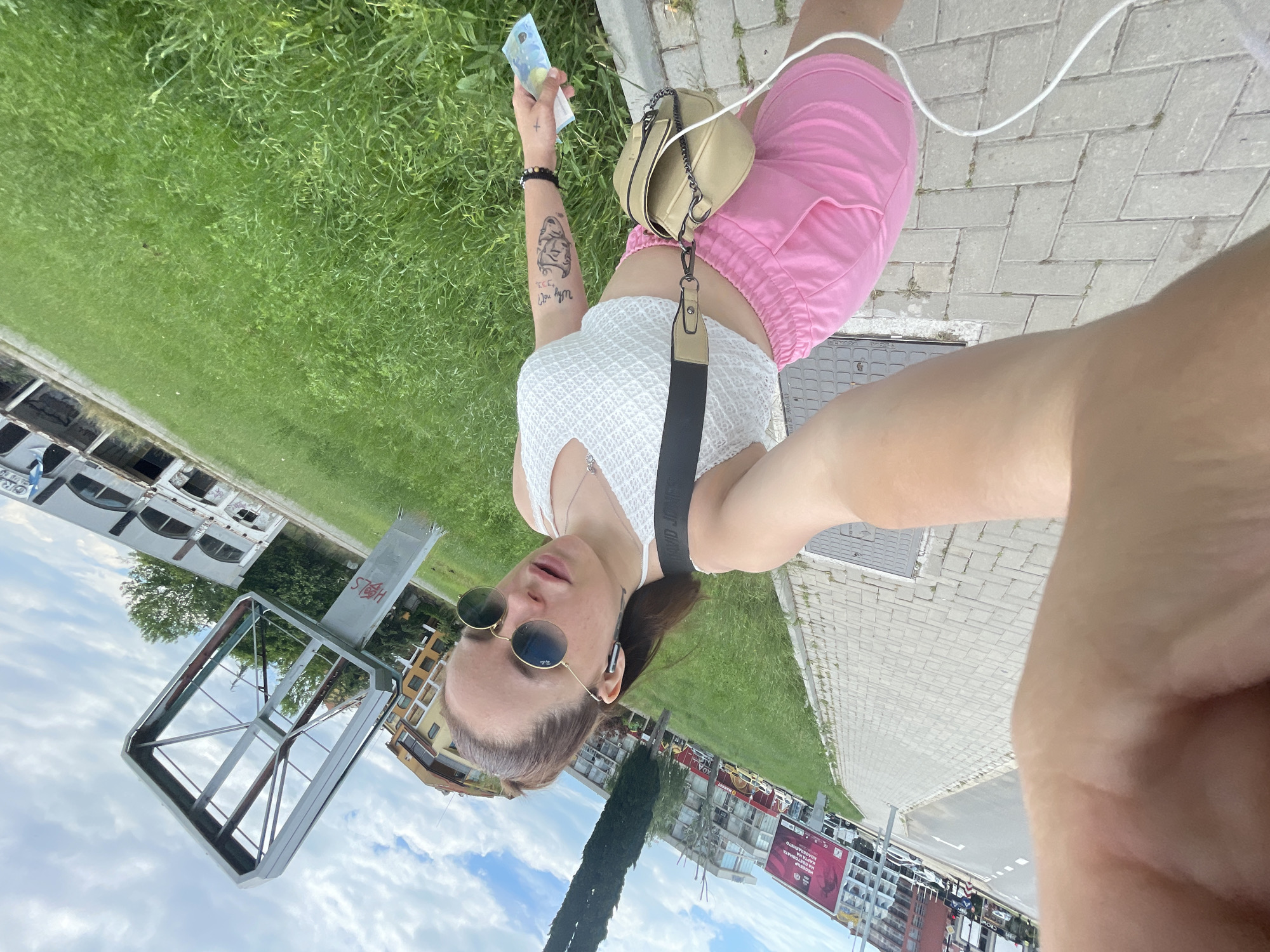 Tourist takes selfie with euro bill in Nesebar