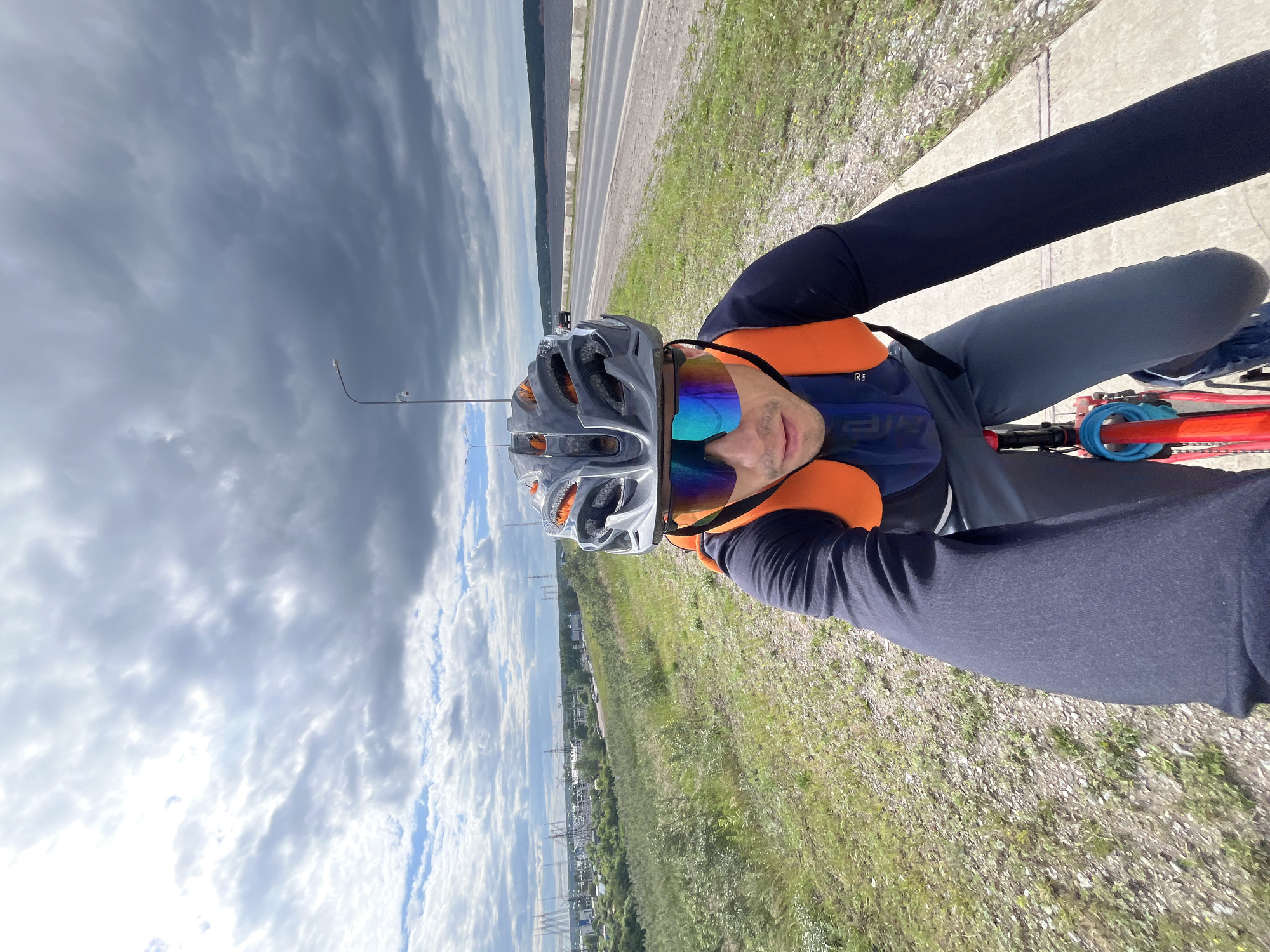 Cyclist rides riverside path in Chaikovsky, Russia