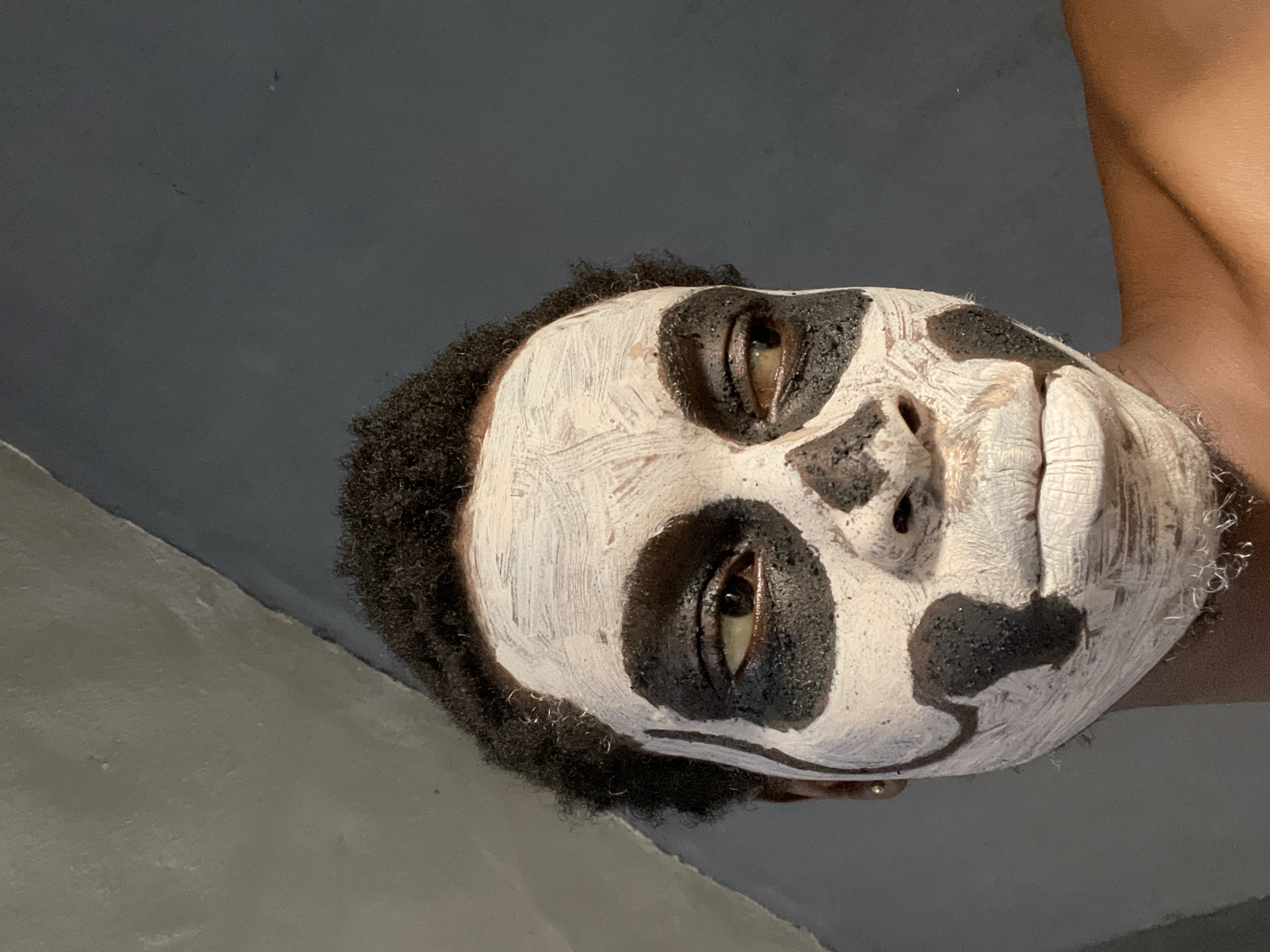 Person poses for skull face paint portraits in Onitsha