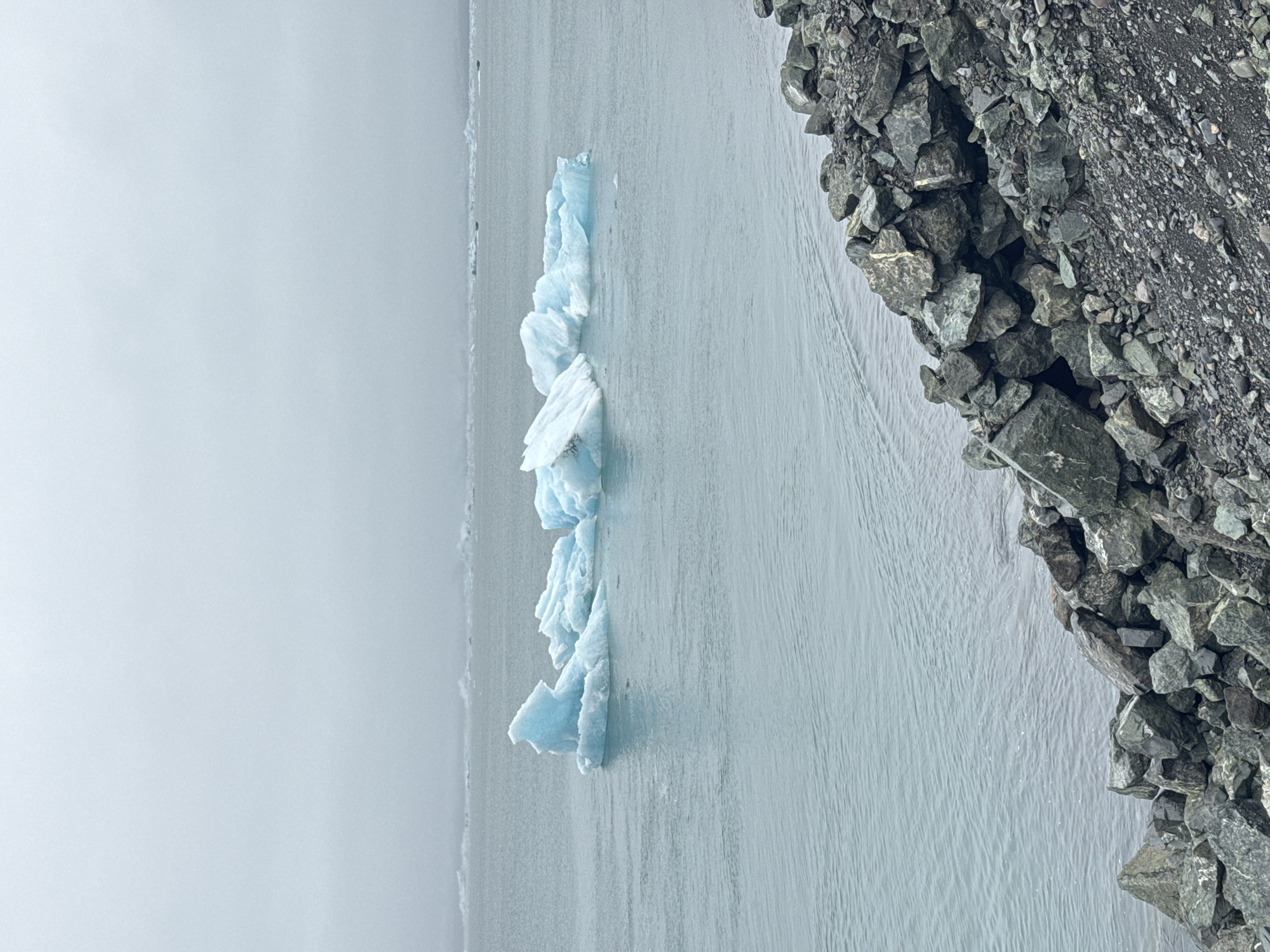 Glacier edge meets water in Icelandic lagoon scene