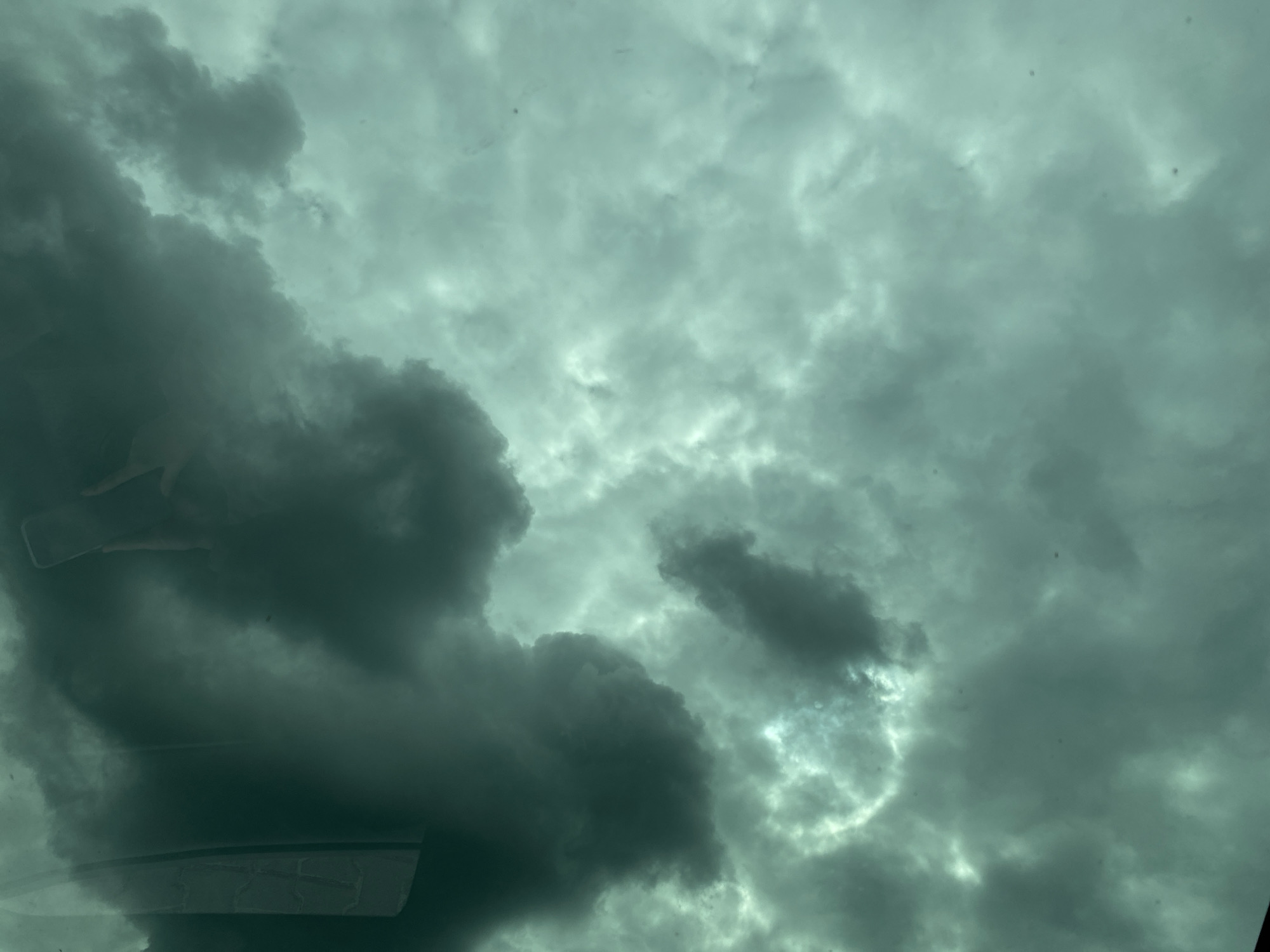 Driver captures stormy skies, unicorn road sign during journey