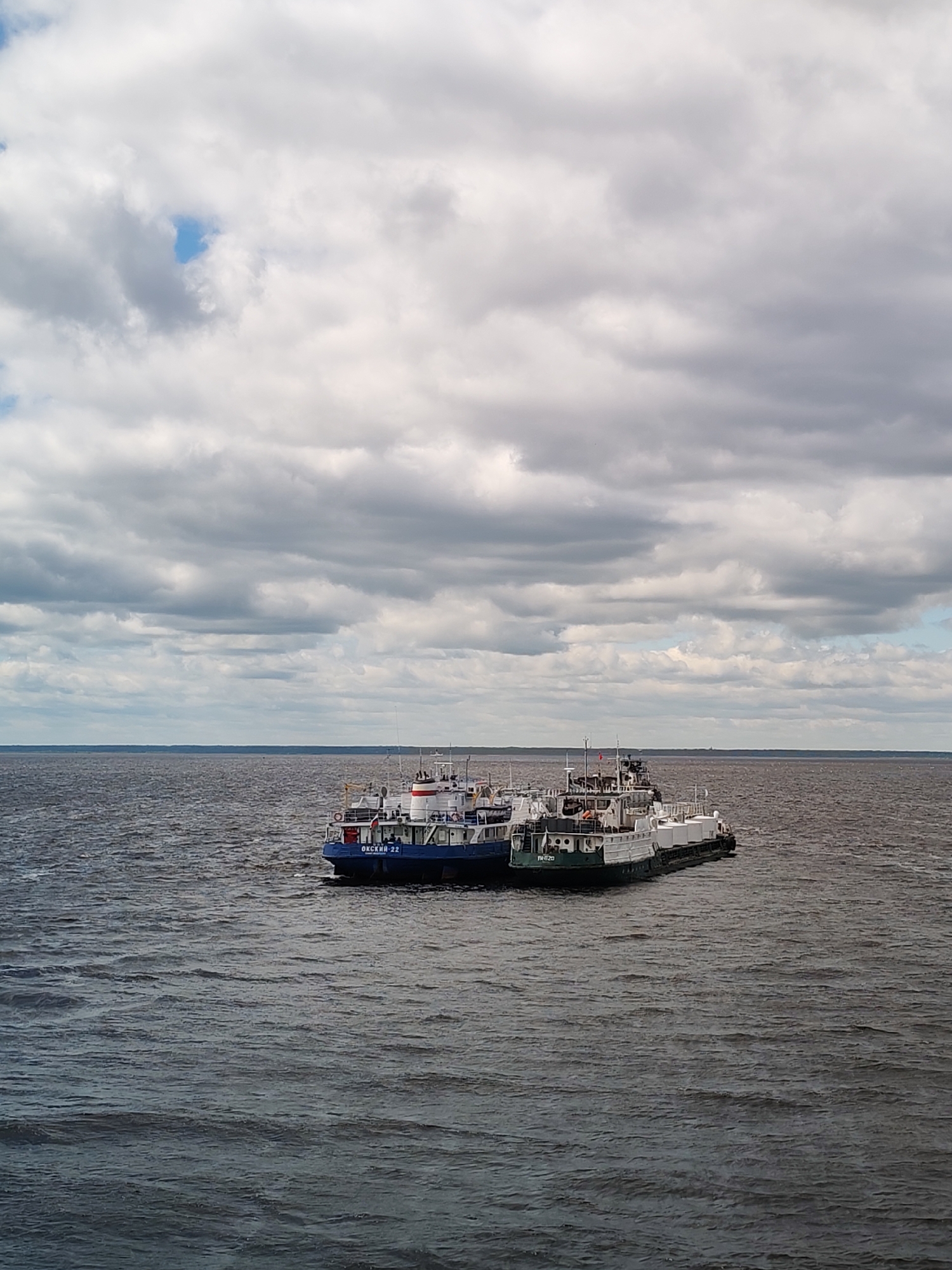 Connected vessels spotted on dark water, observer watches from cabin
