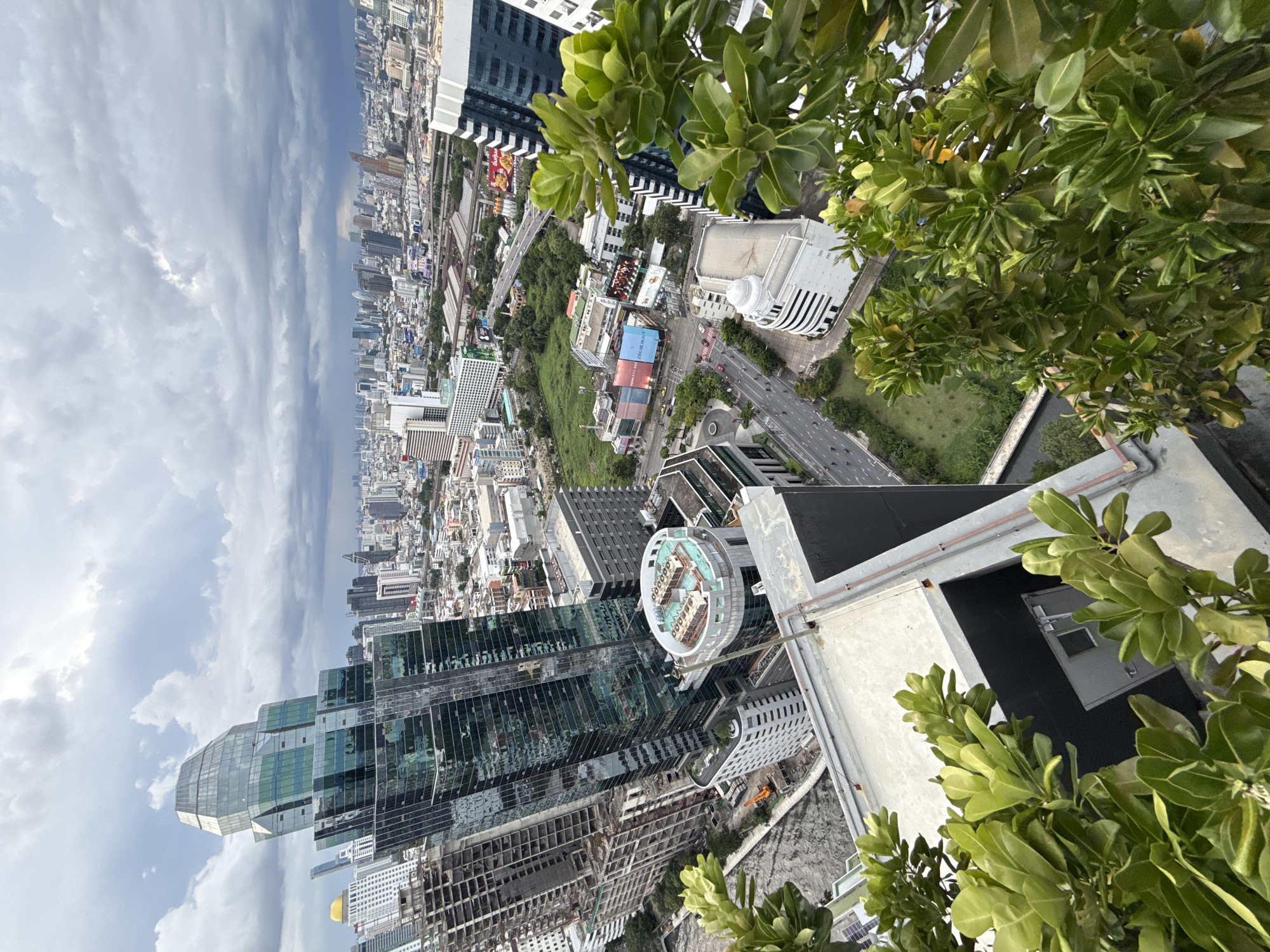 Rooftop views over Bangkok's skyline on a cloudy afternoon