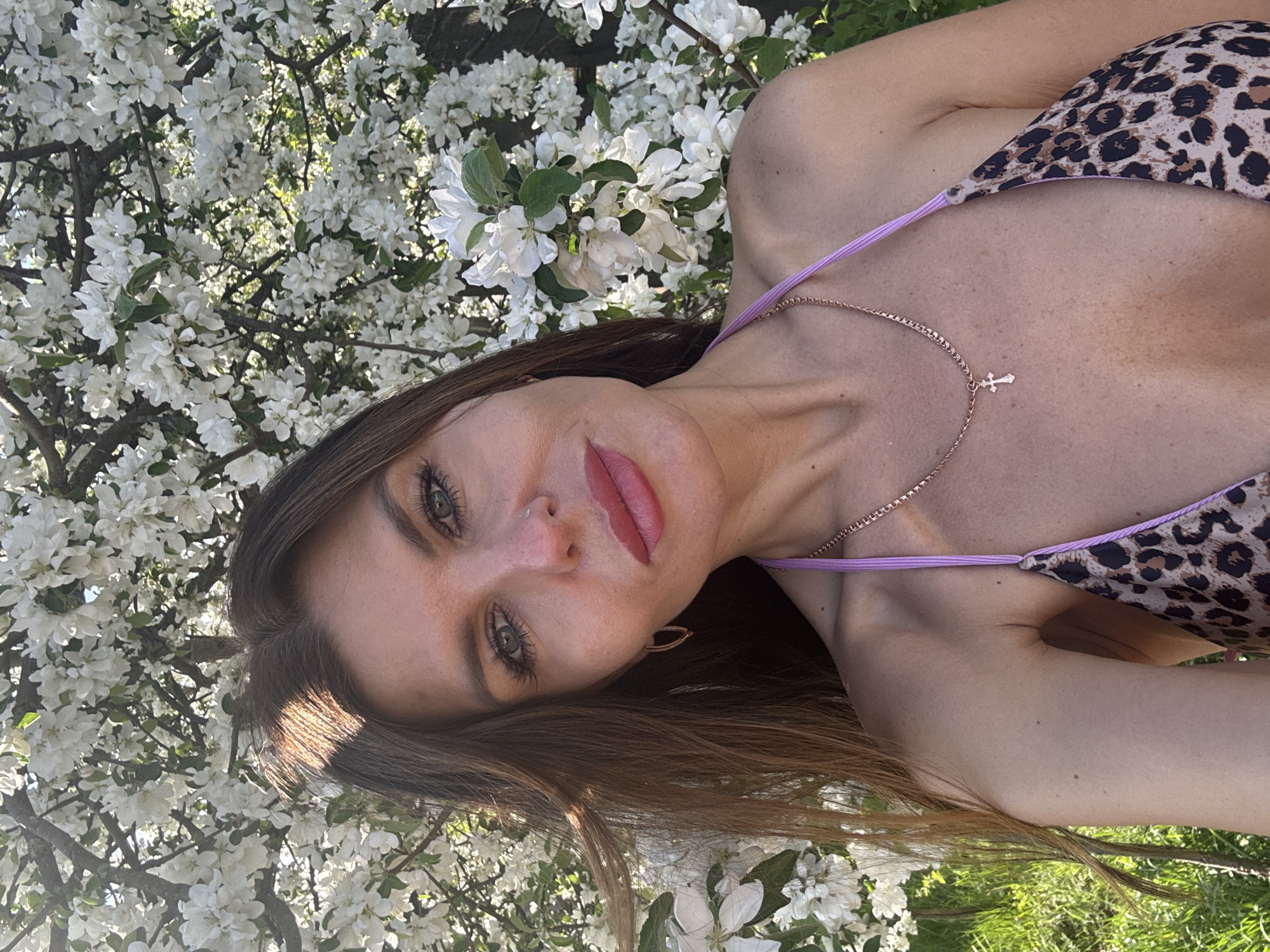 Woman photographs spring blossoms photo session in Dubovaya, Russia