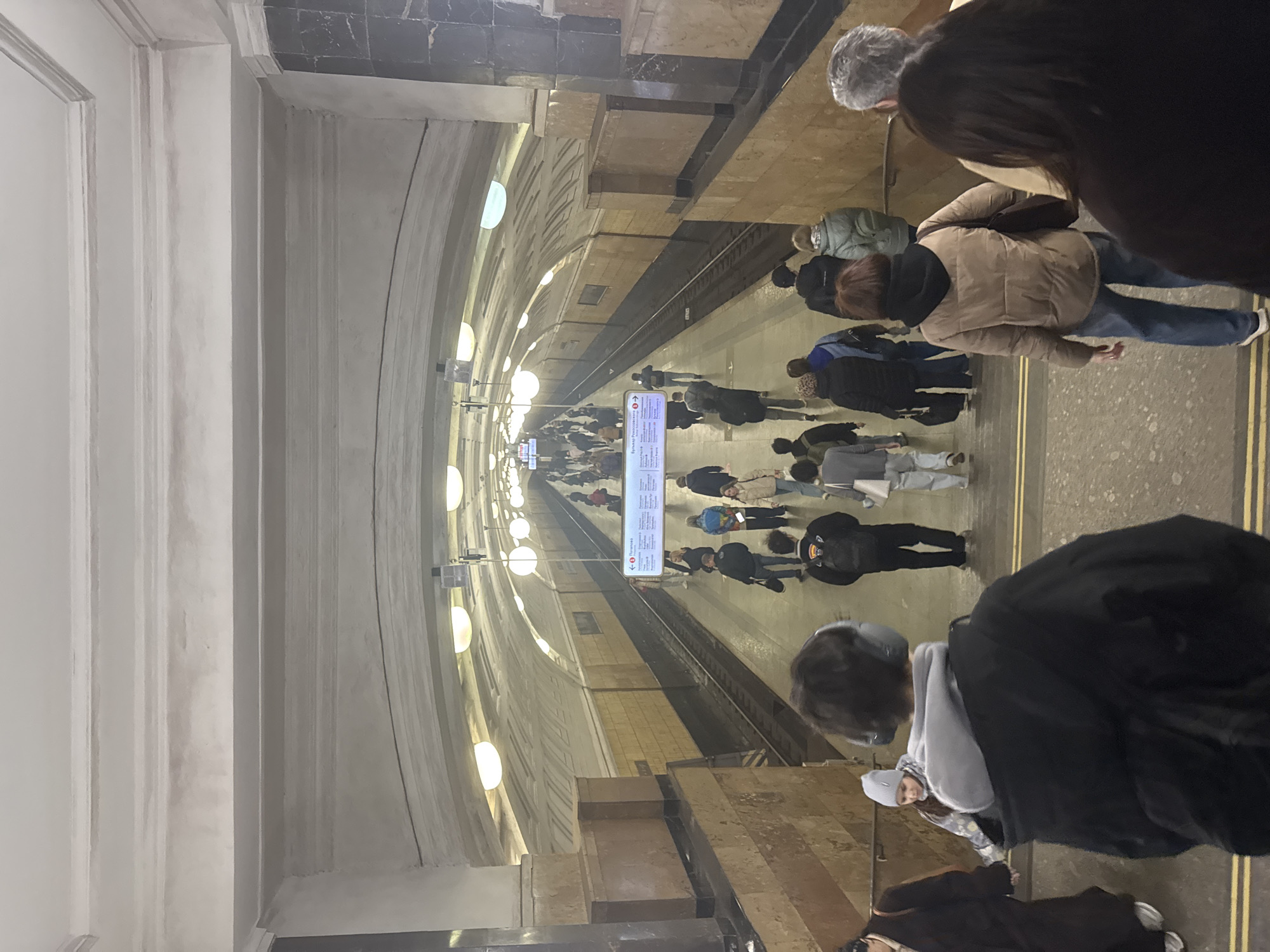 Moscow commuters wait on subway platform during morning rush