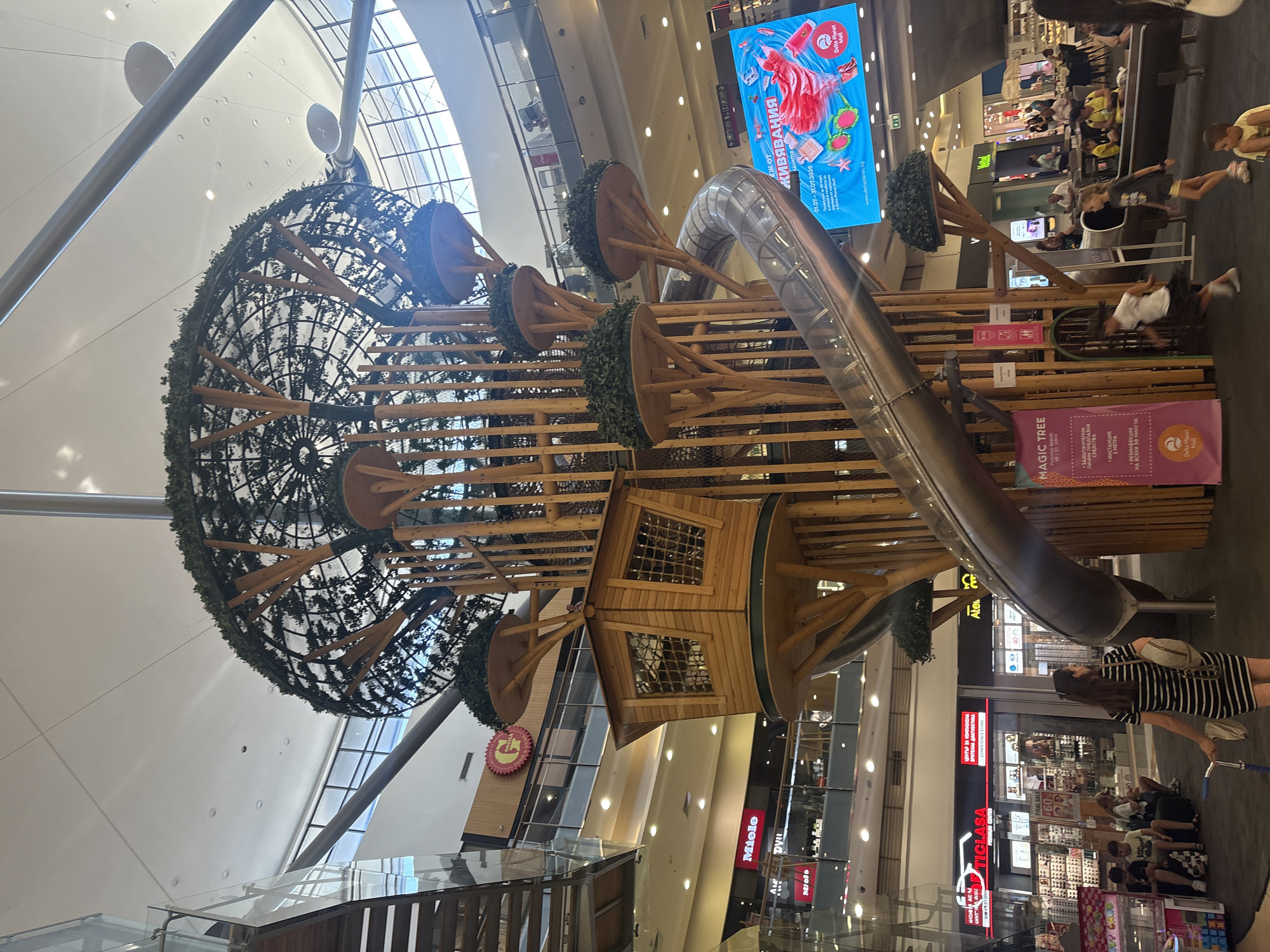 Whimsical treehouse play structure inside a shopping mall