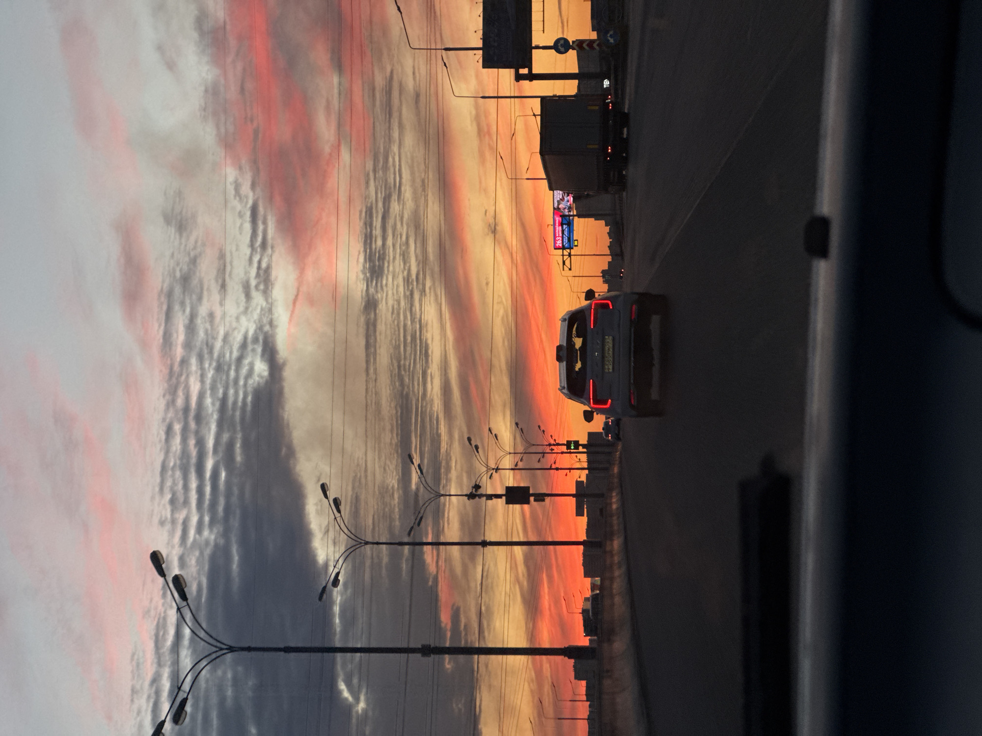 Sunset sky over Dzerzhinsky highway, shot from a moving vehicle