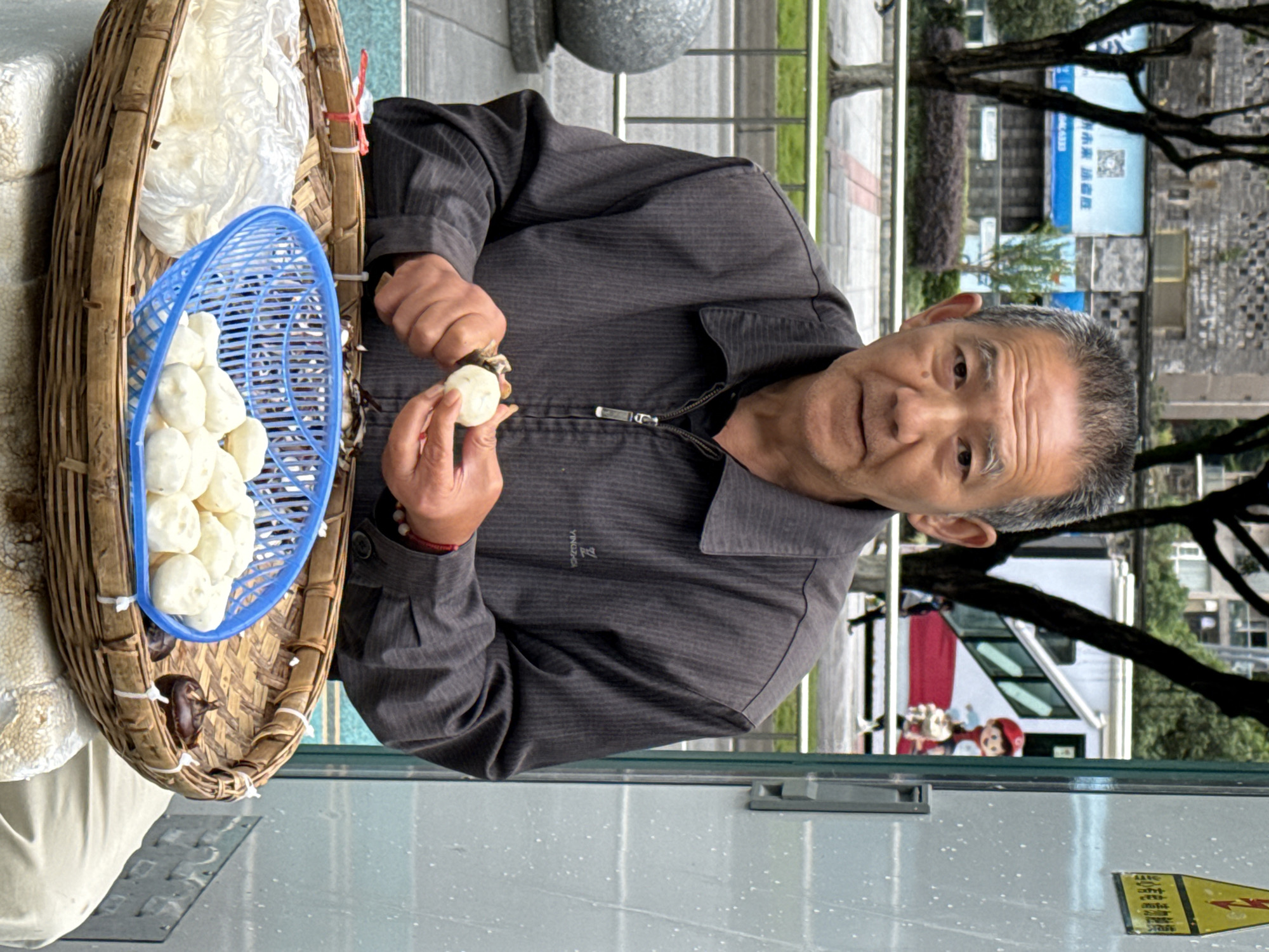 Elderly street vendor prepares food in Jiulongpo District
