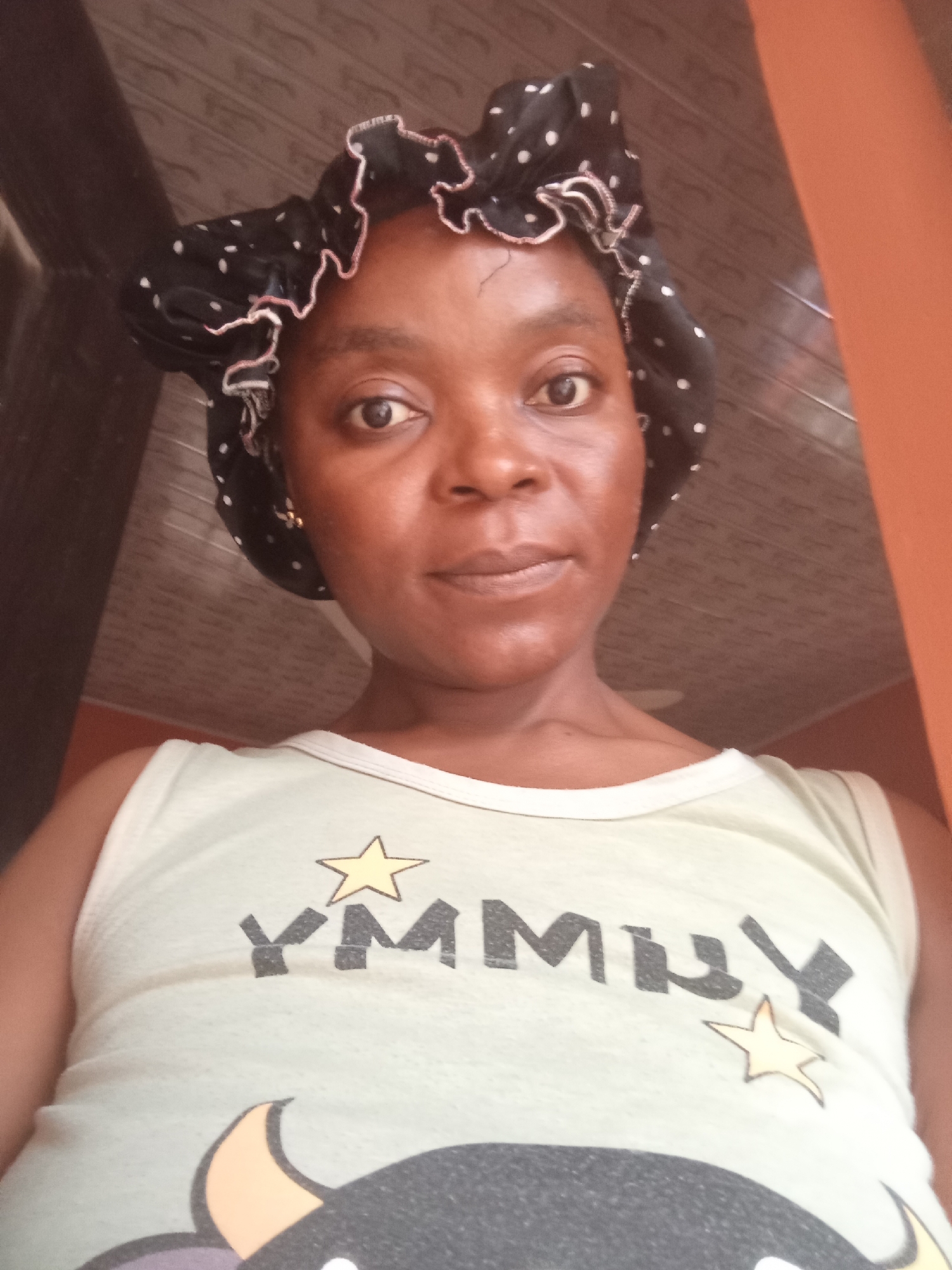 Multiple selfies, same bonnet and 'YUMMY' tank top, slightly varied angles.