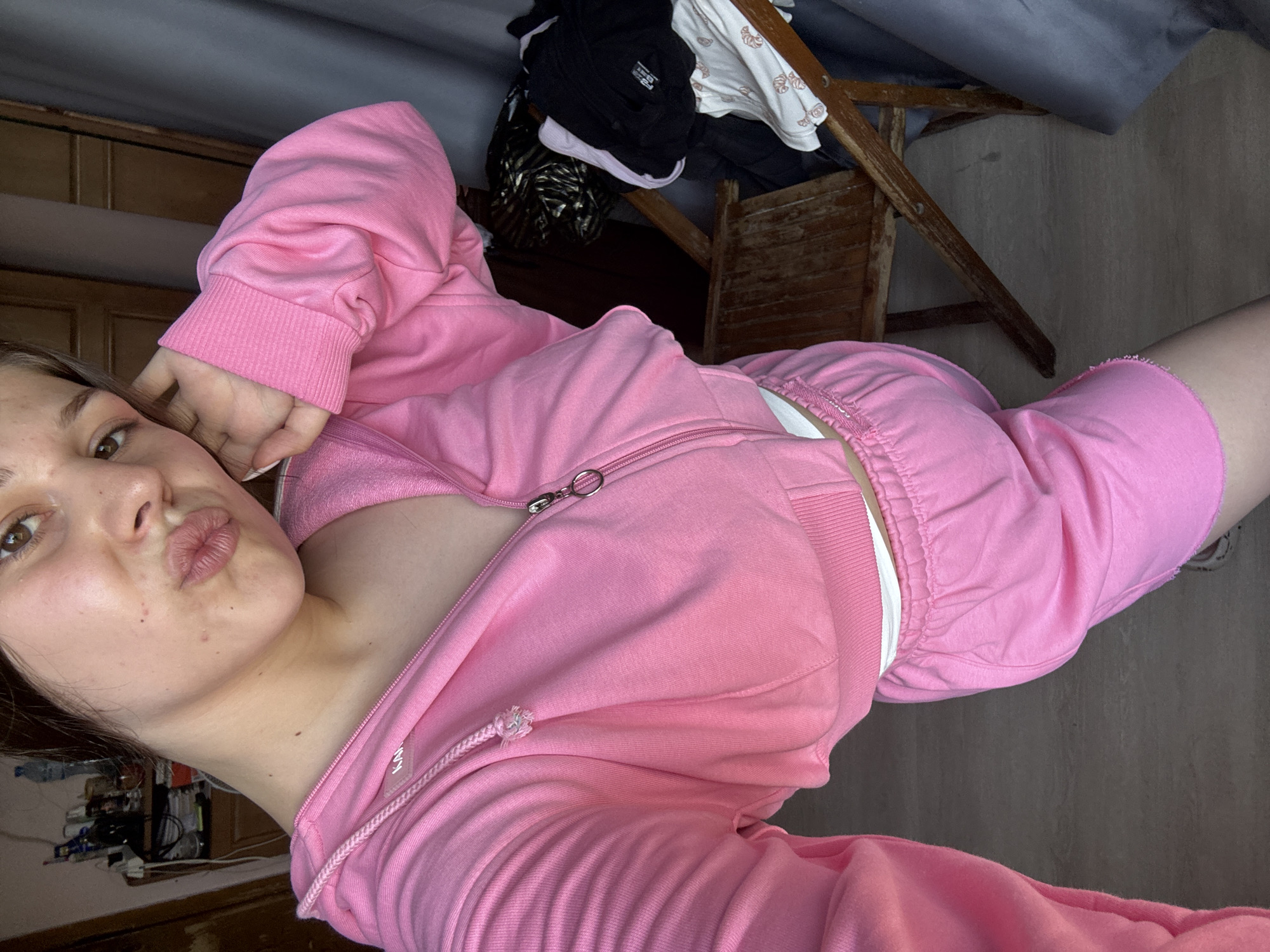 Bedroom selfie session in a pink tracksuit
