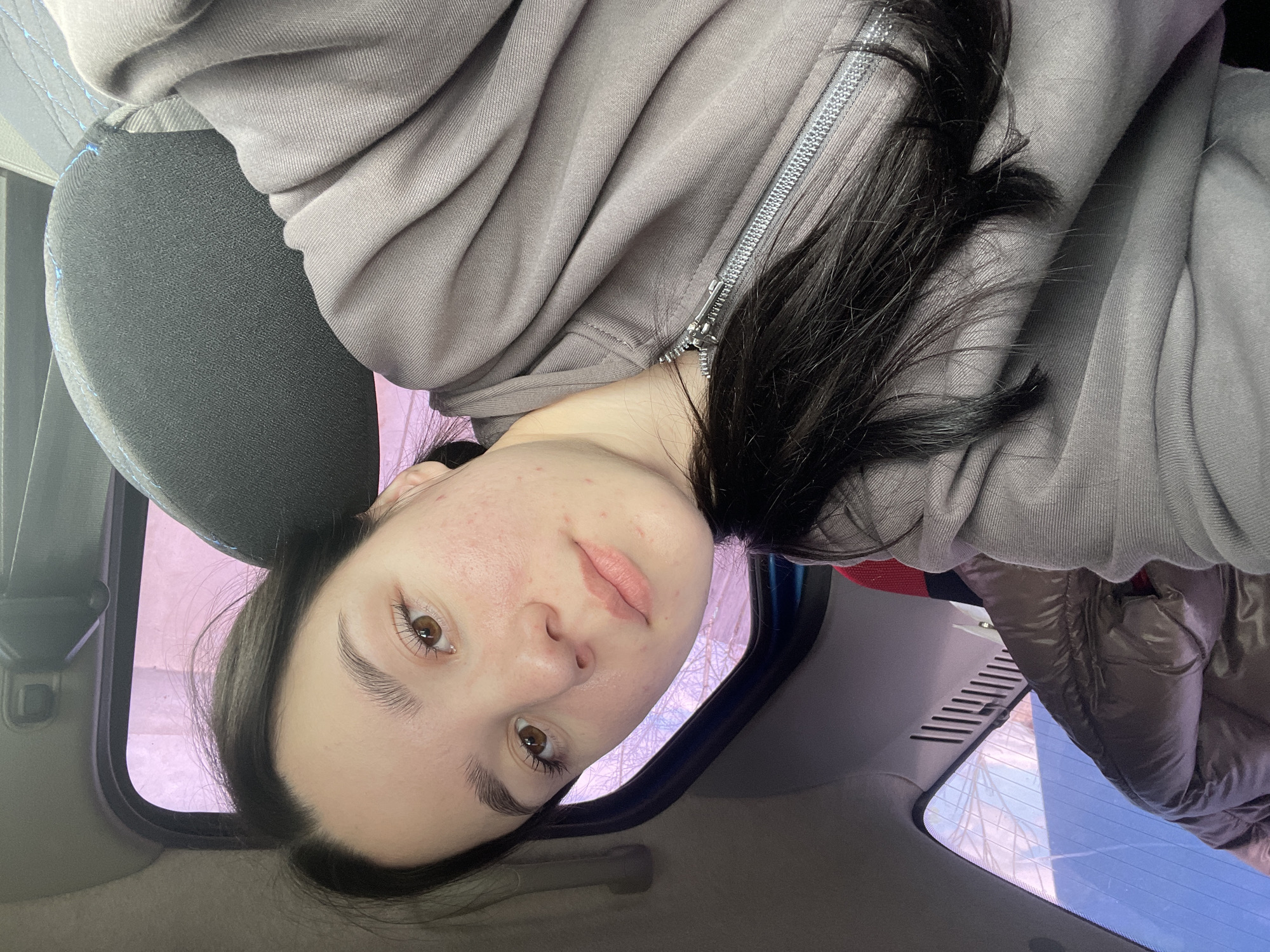 Woman and dog photographed together inside car in Russia