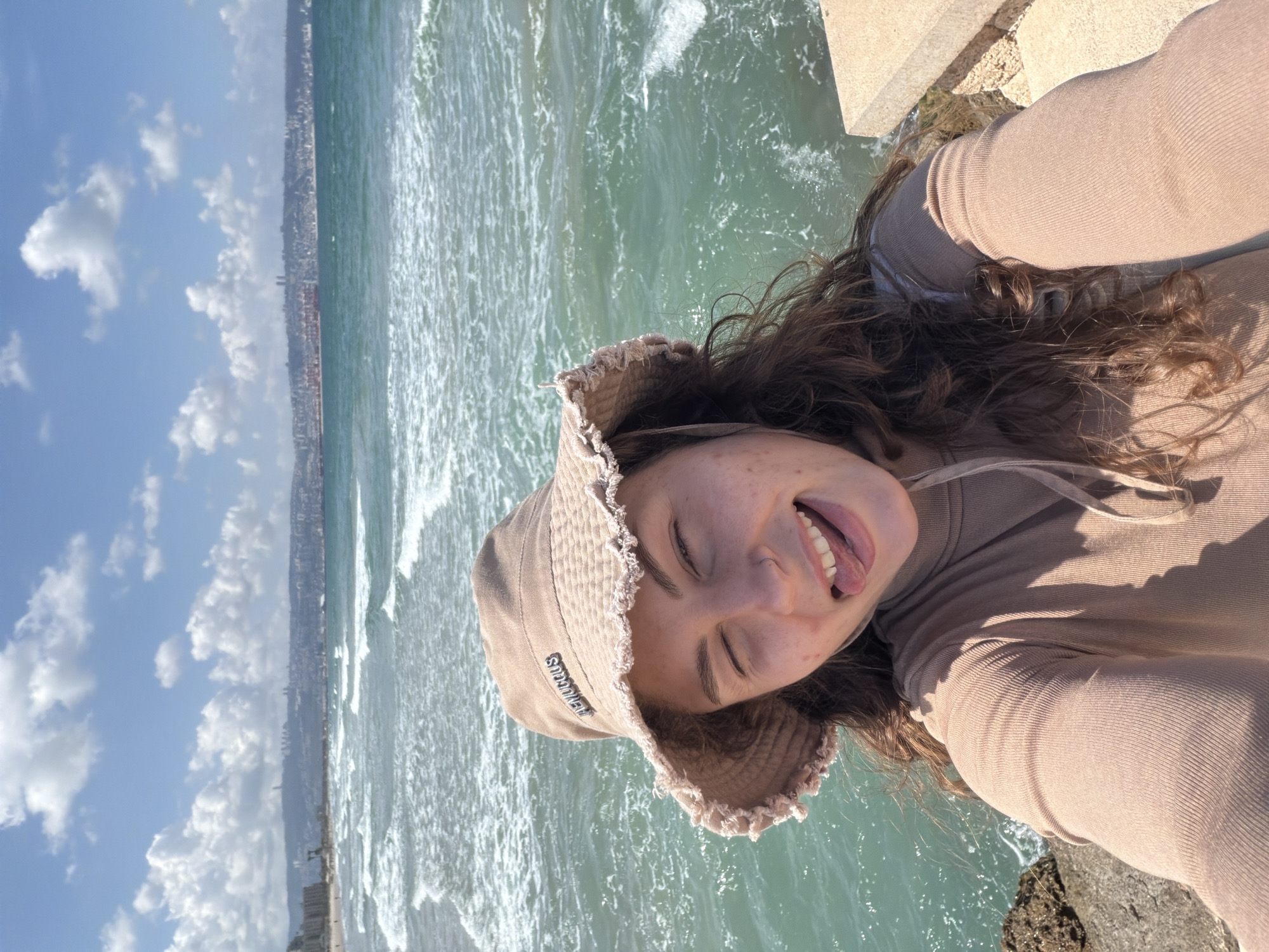 Woman takes seaside selfies on Kiryat Yam promenade