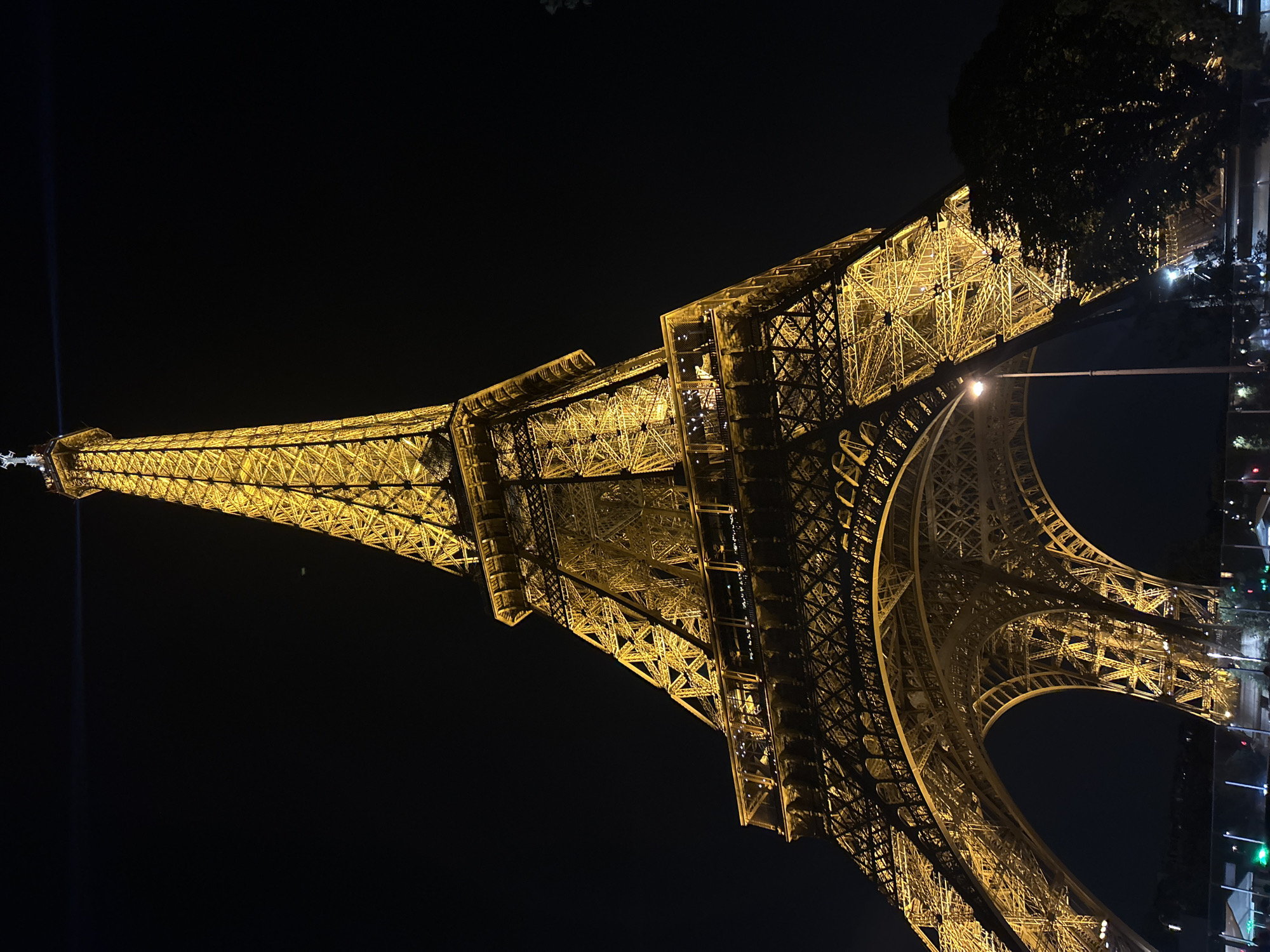 Eiffel Tower glowing gold on Bastille Day night