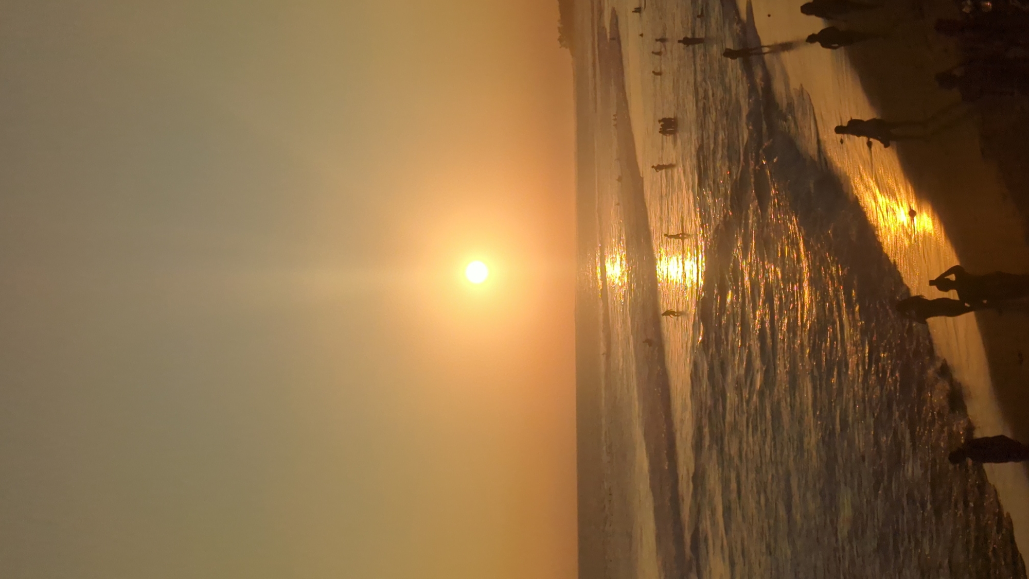 Sunset documented at North Kuta beach with musician, cafe patrons