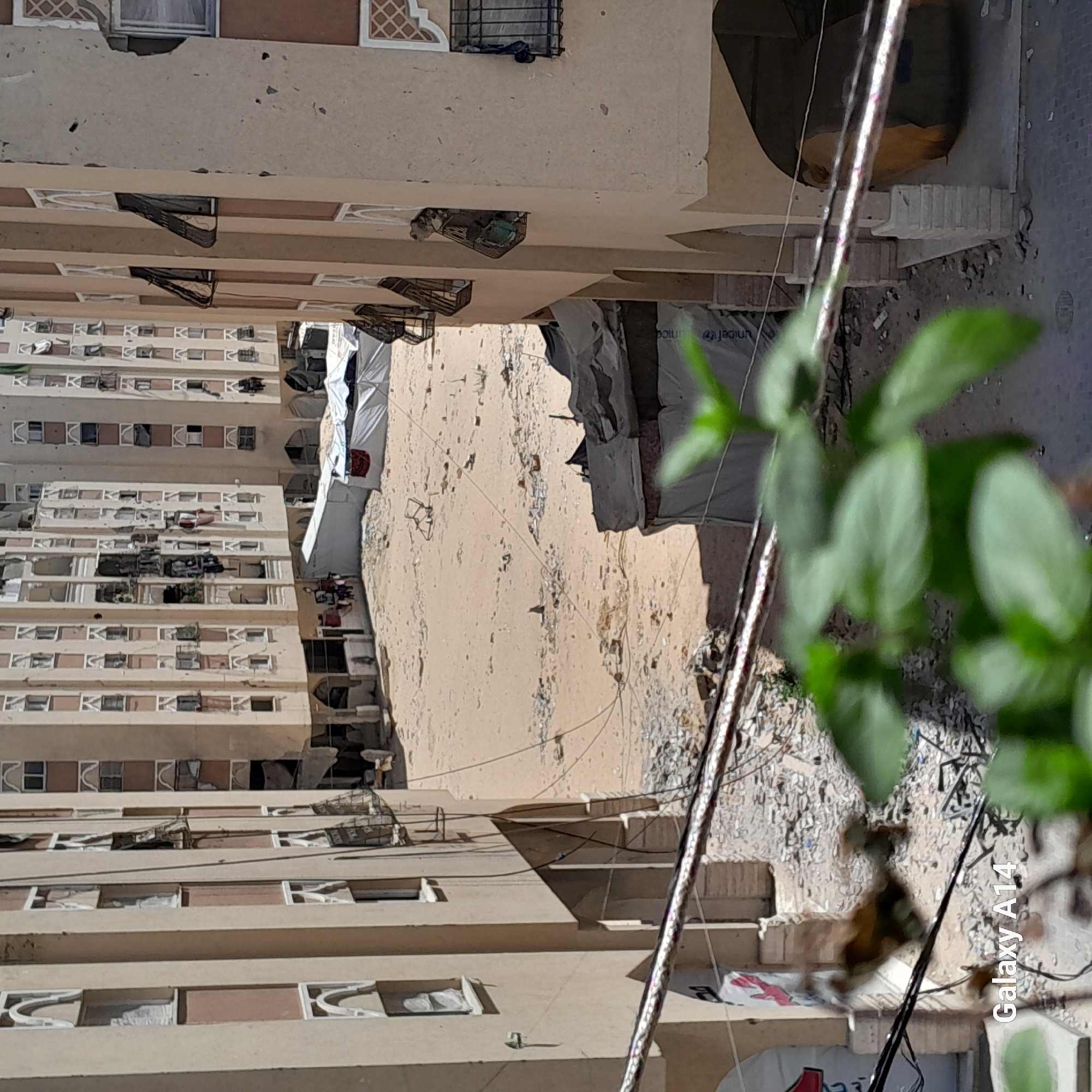 Damaged buildings and displacement camps in Khan Yunis